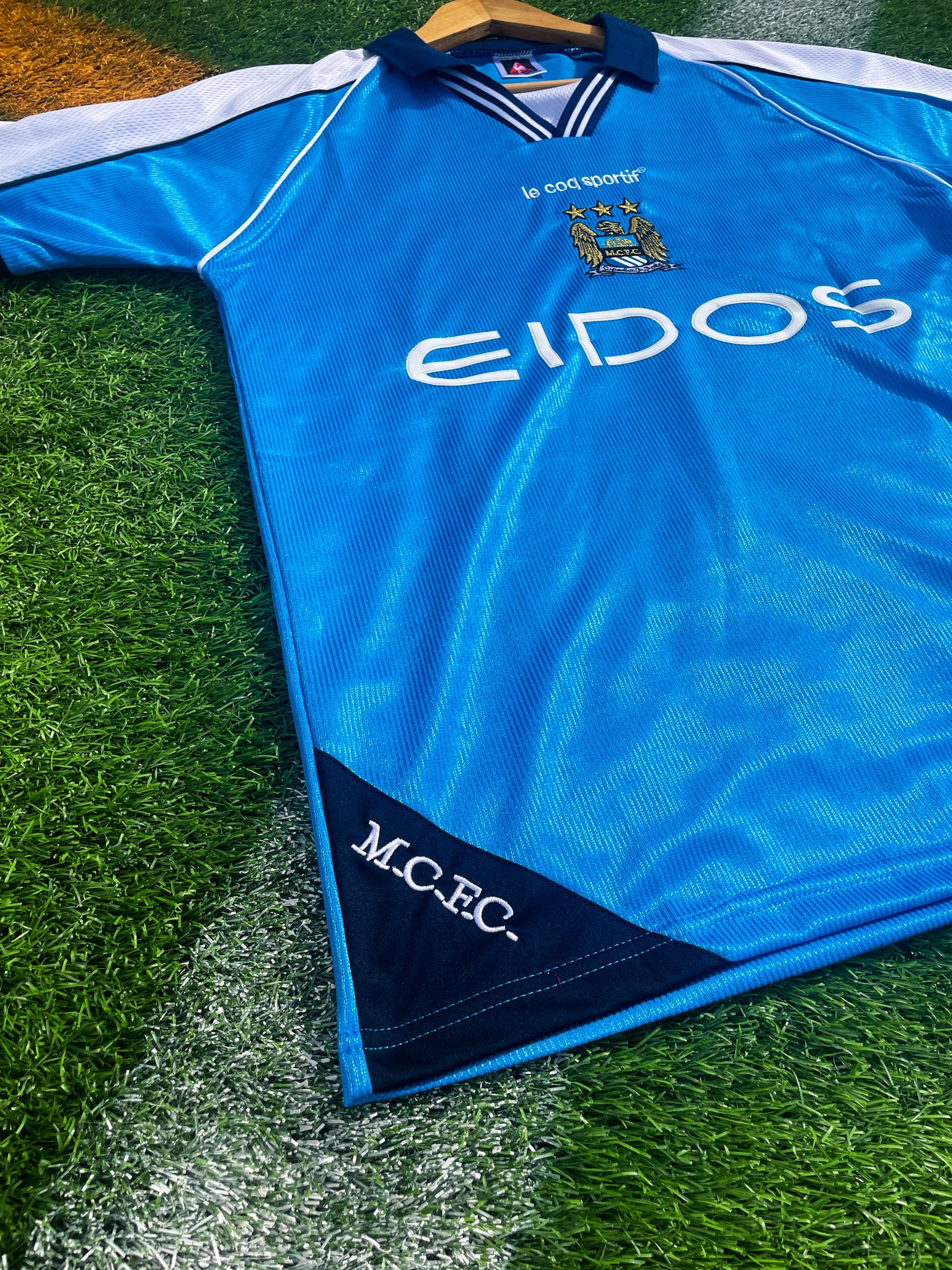 Close-up of sponsor logos and embroidered crest details

