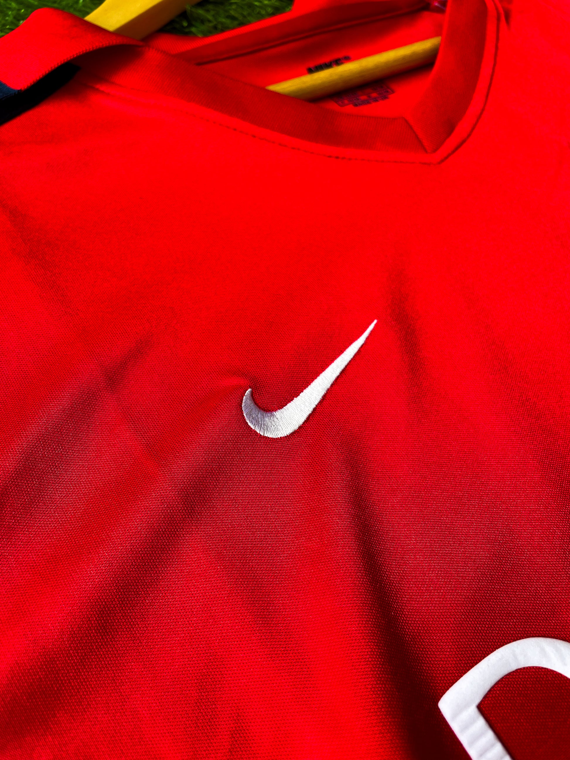 Close-up of Dreamcast sponsor and Nike swoosh on vintage Arsenal shirt

