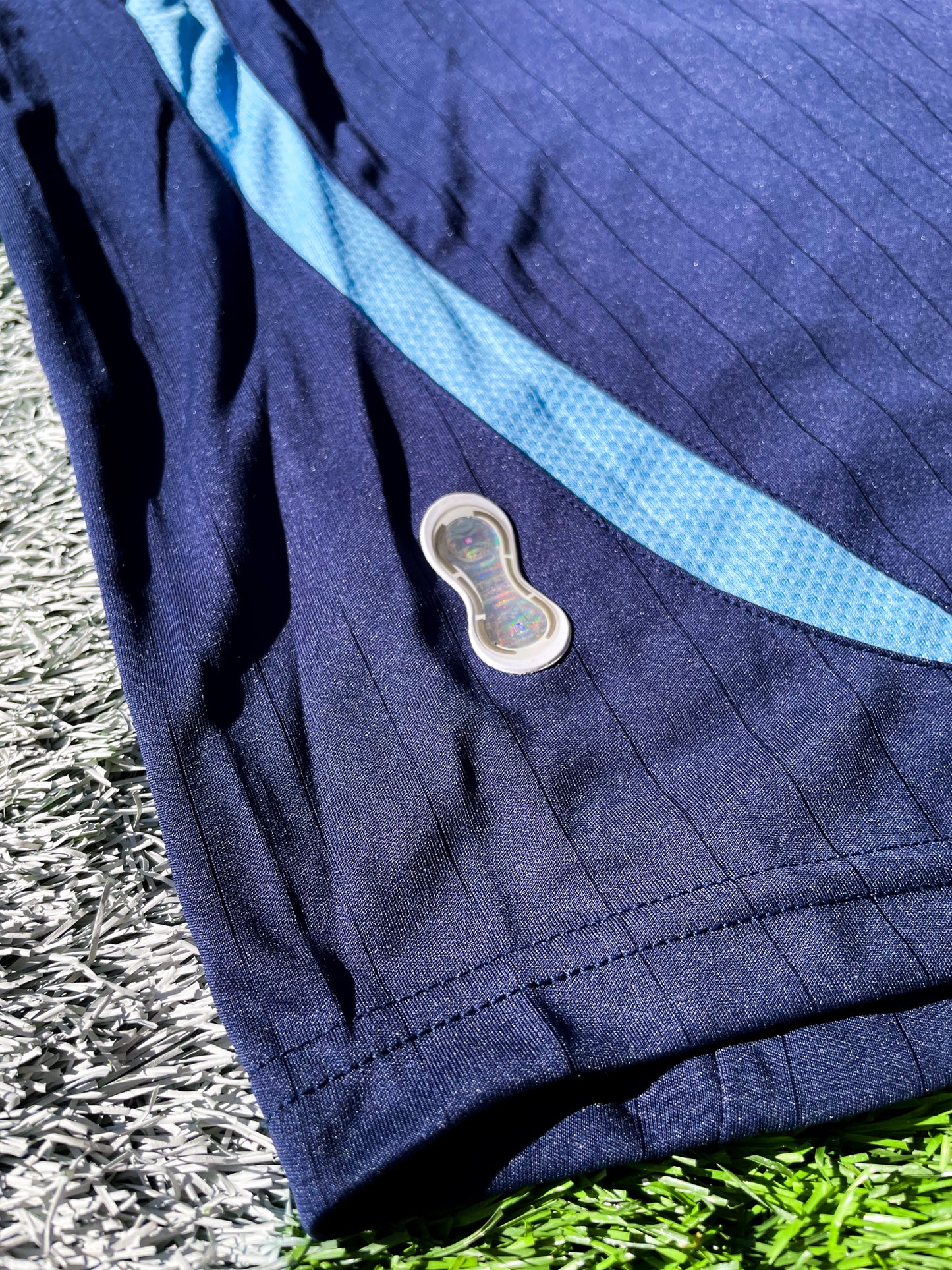 Detailed shot of the jersey's fabric texture and sky blue accents.