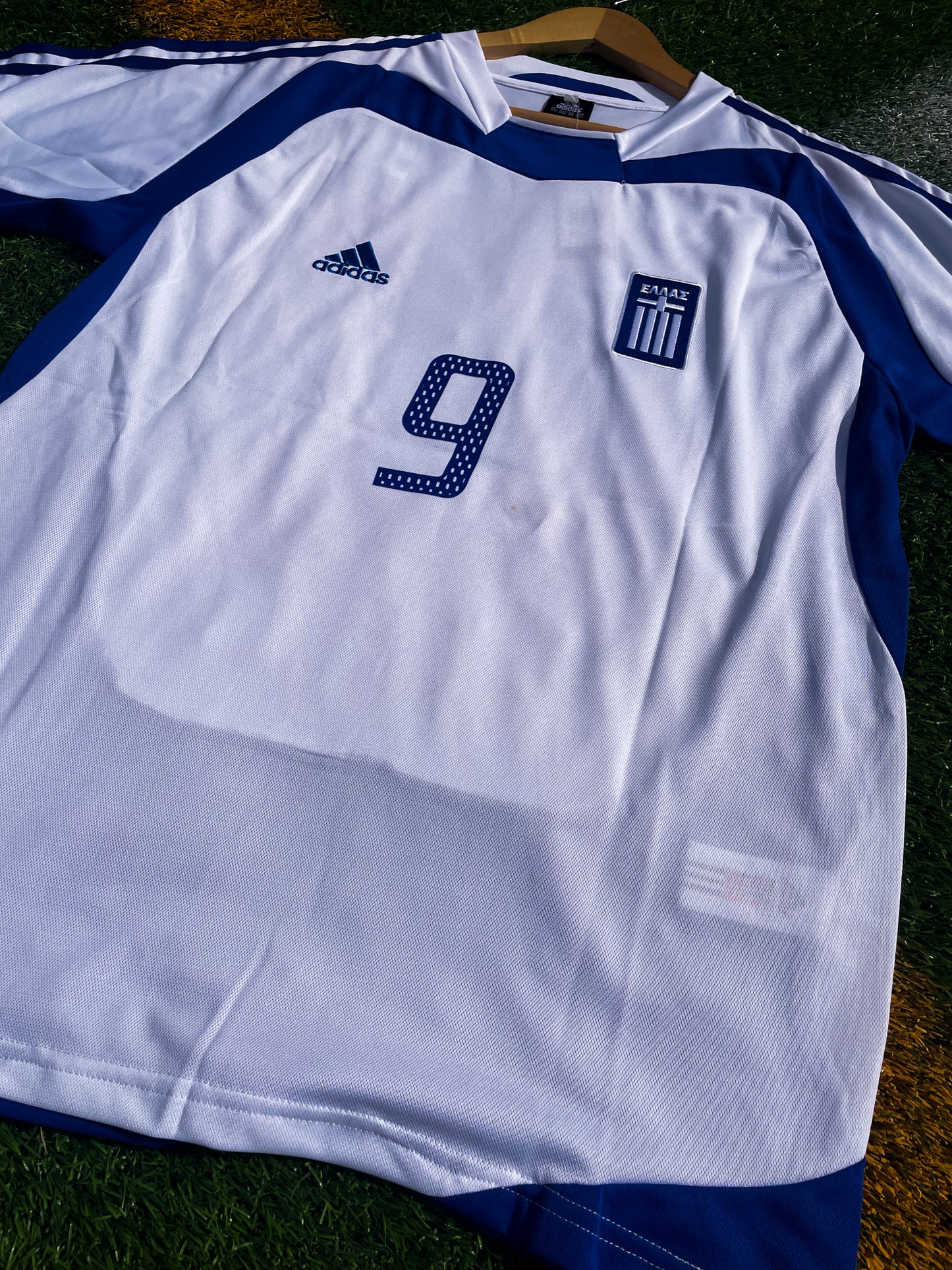 Close-up of Hellenic Federation crest and Adidas logo

