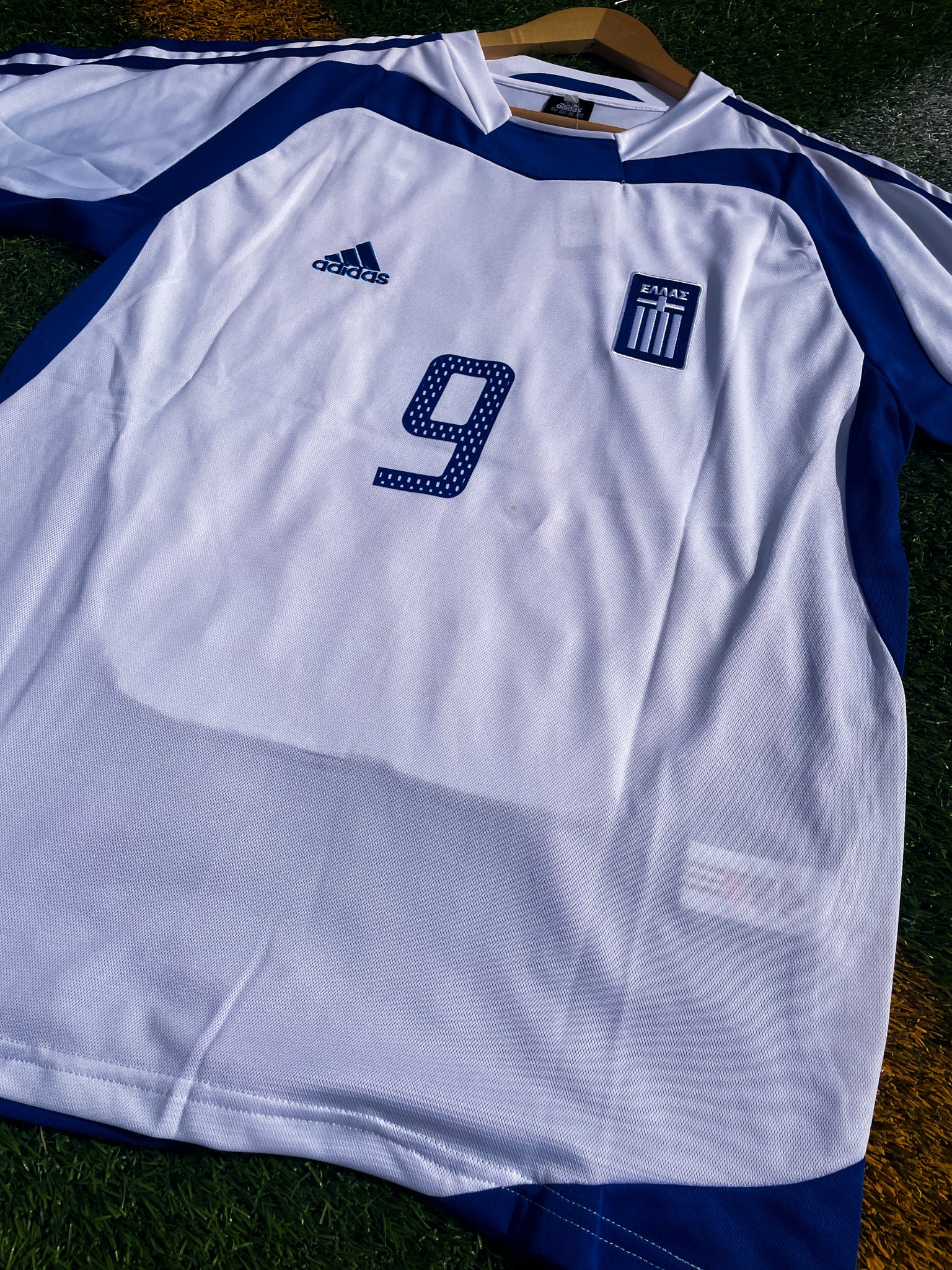 Close-up of Hellenic Federation crest and Adidas logo

