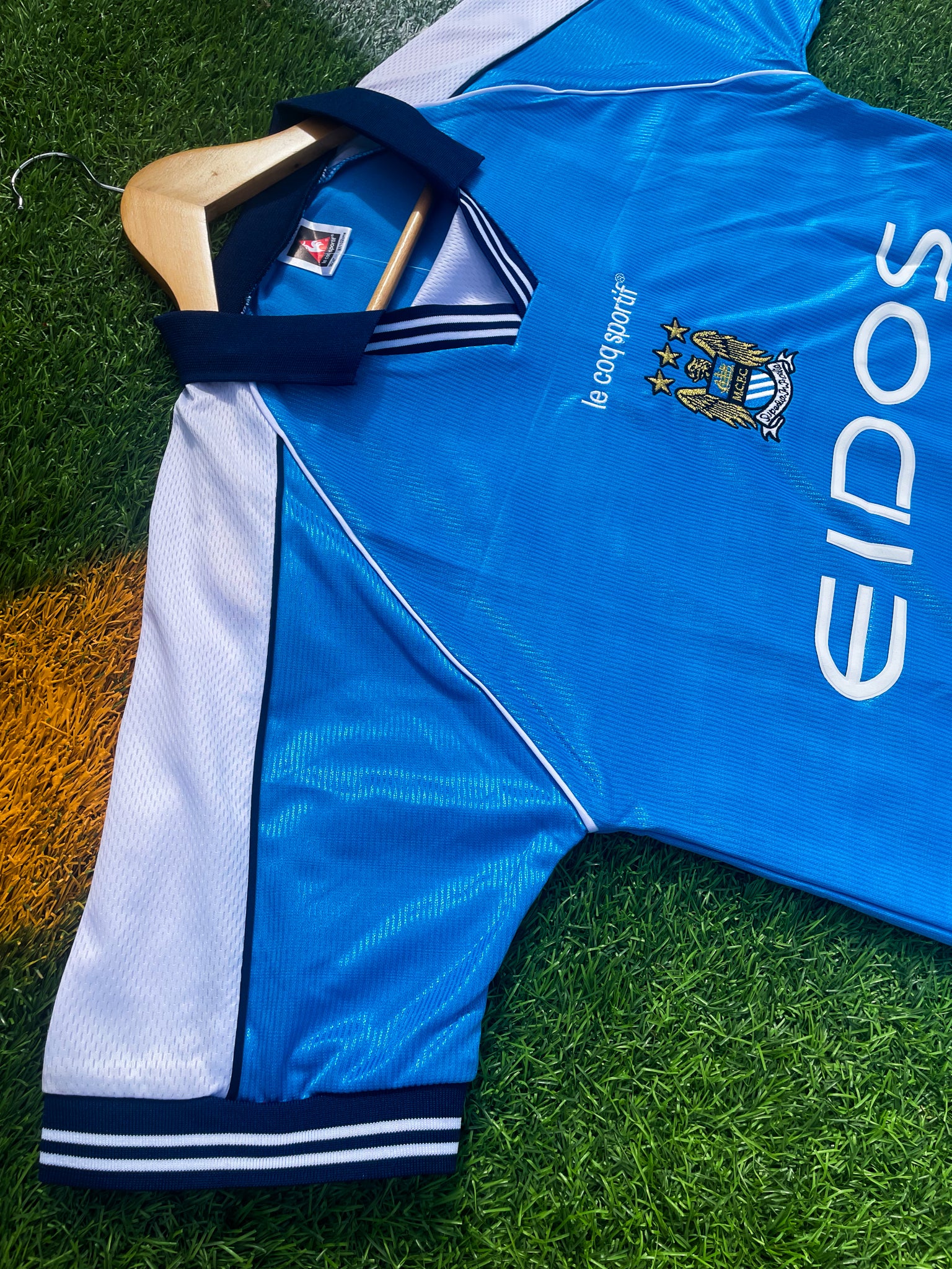 Close-up of sponsor logos and embroidered crest details

