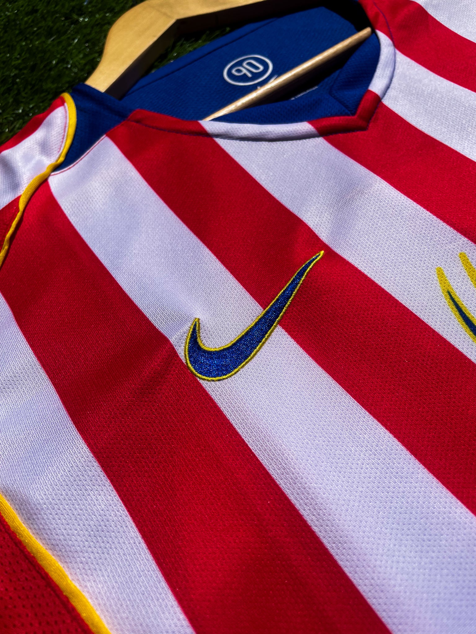Close-up of Spiderman sponsor logo and embroidered club crest

