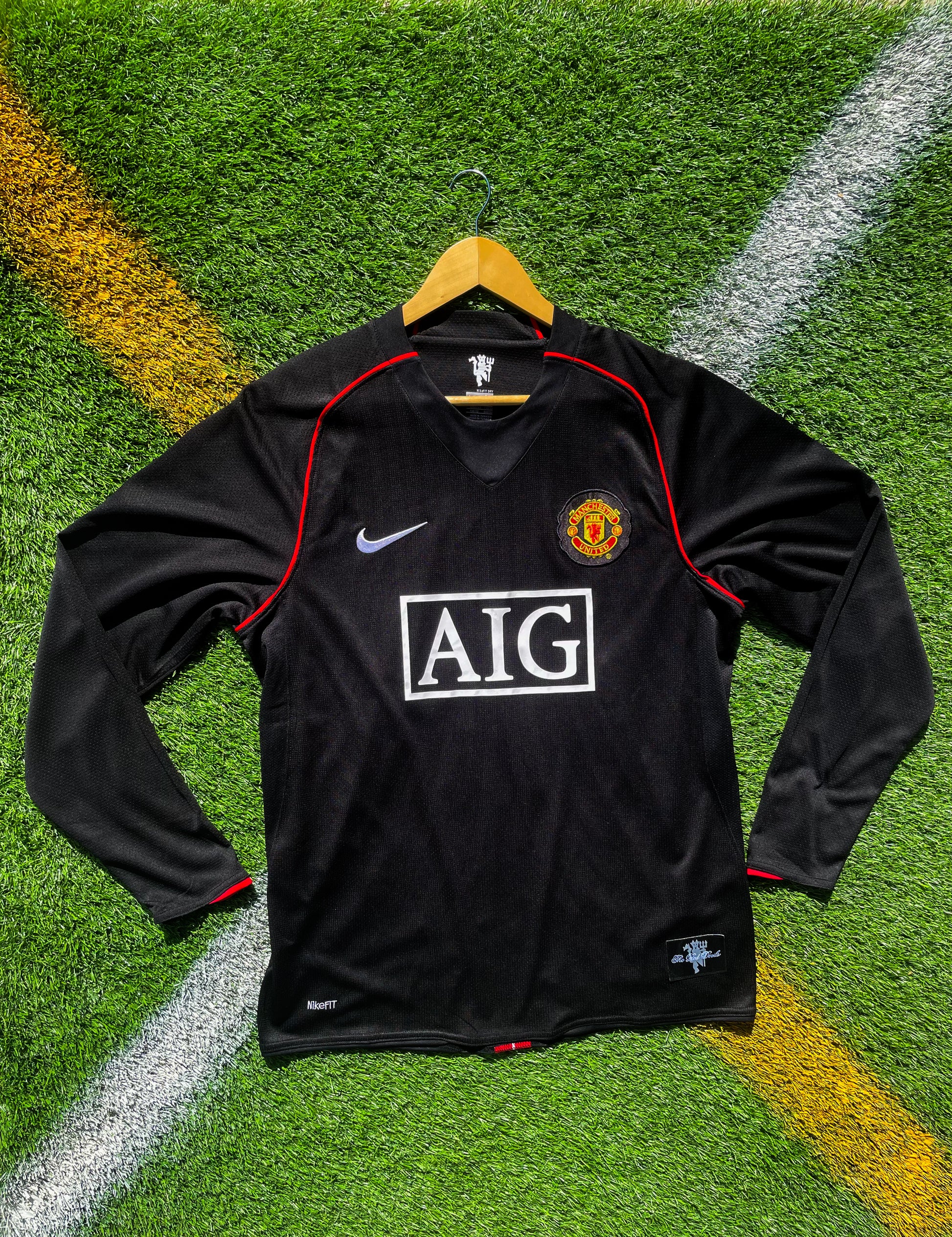 Front view of black Manchester United 2007–2008 away jersey with AIG sponsor

