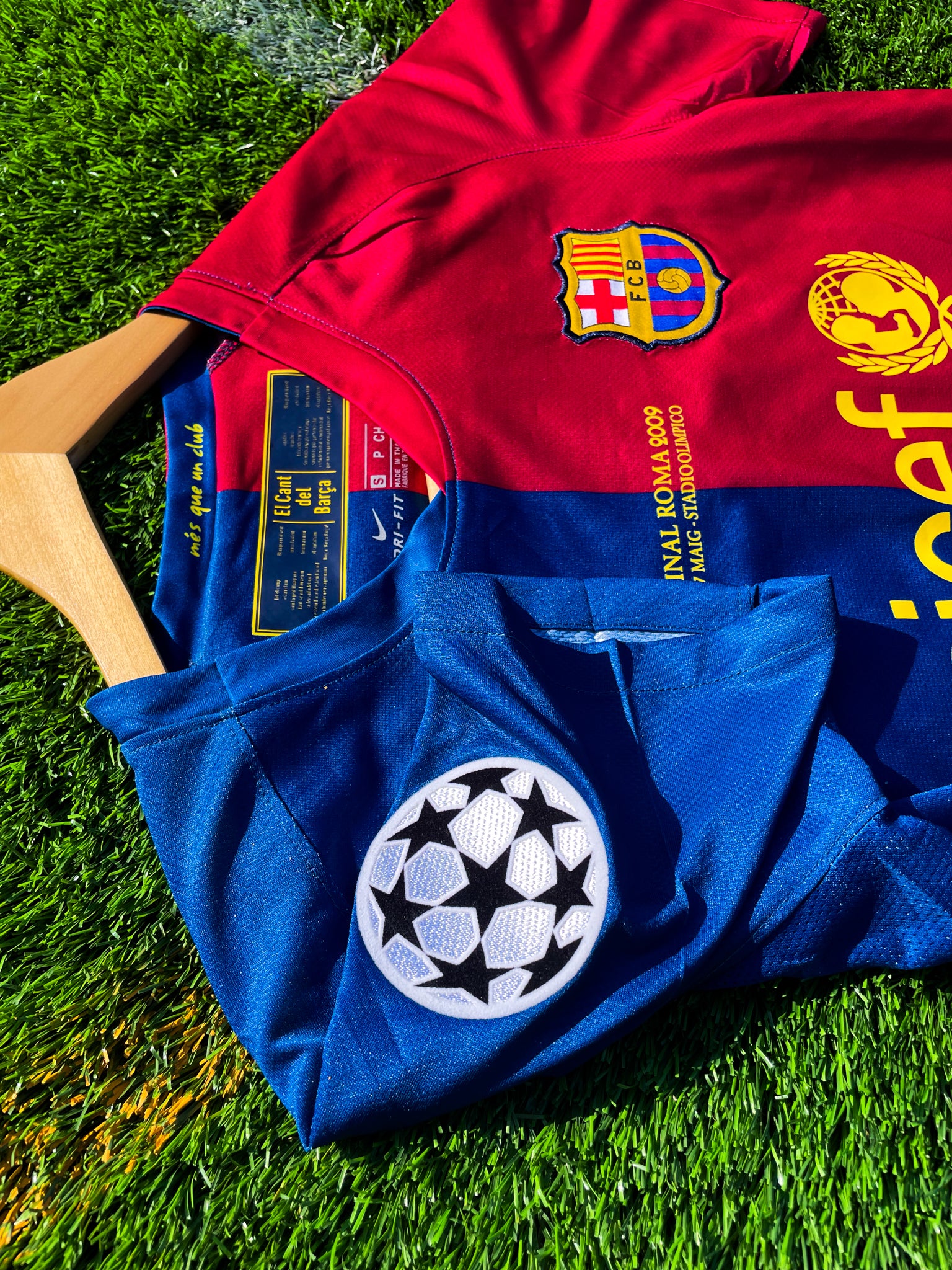 Close-up of Nike logo and club crest on the split-color design

