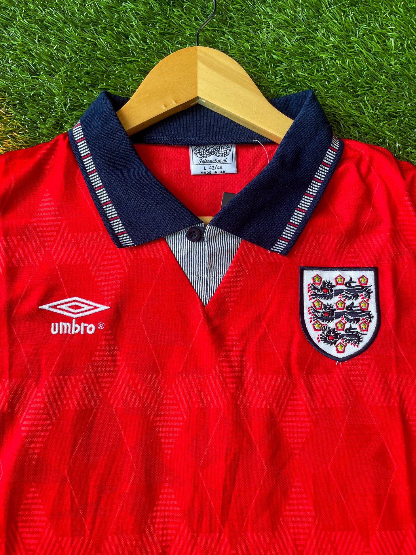 Close-up of Umbro logo and geometric pattern.

