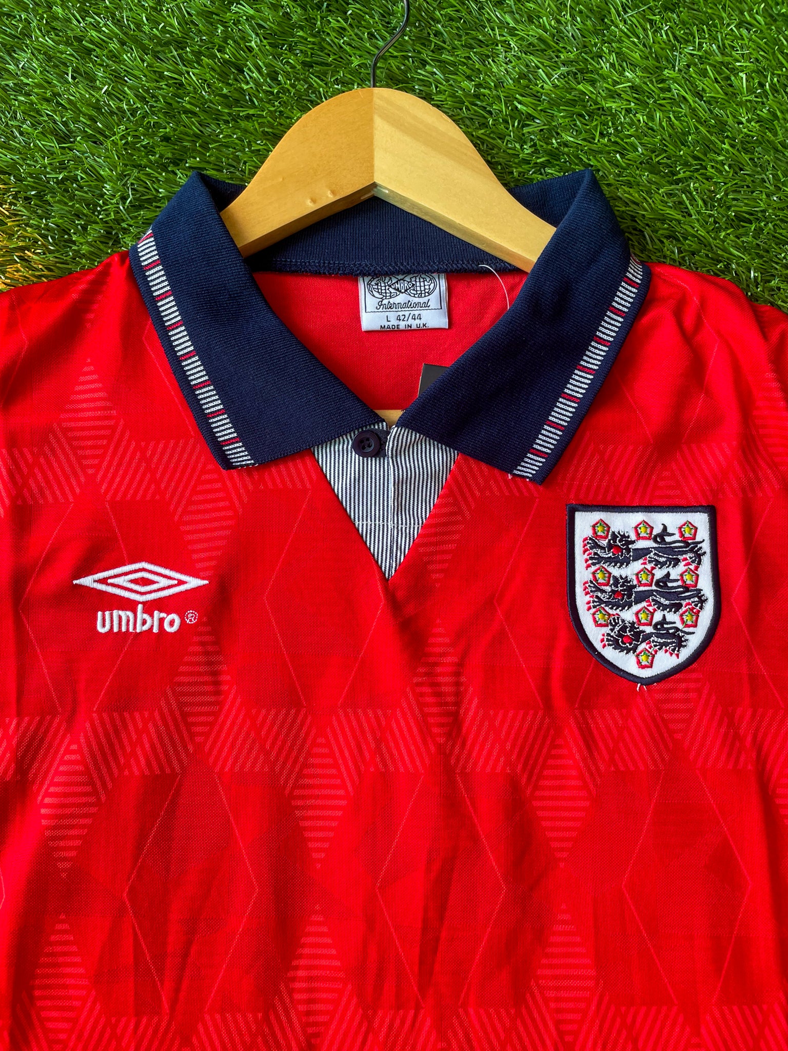 Close-up of Umbro logo and geometric pattern.

