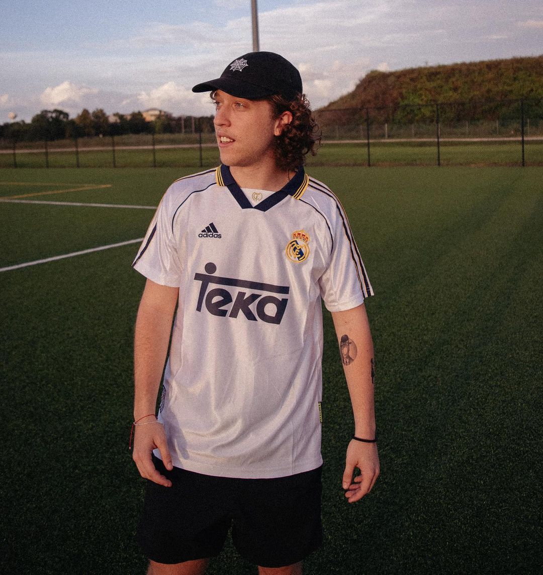 Vintage white Real Madrid home kit styled on a neutral background

