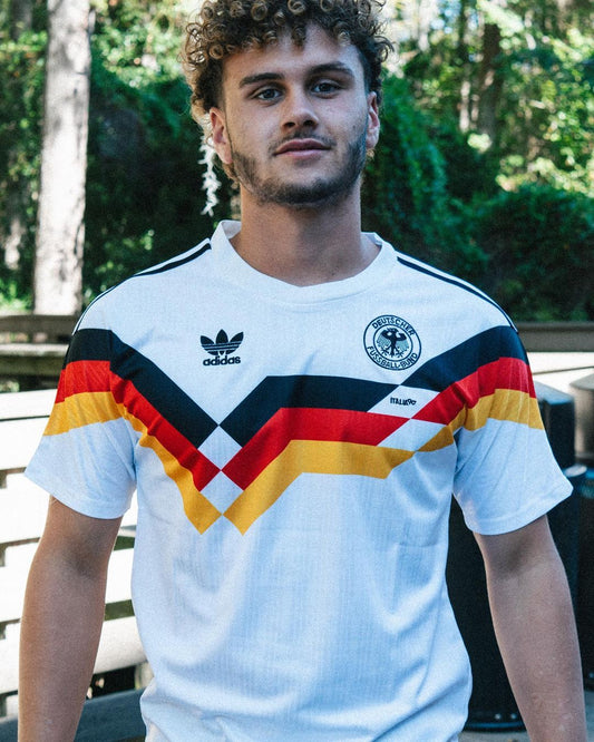 Model wearing the Germany 1990 home jersey styled with streetwear for a retro football look

