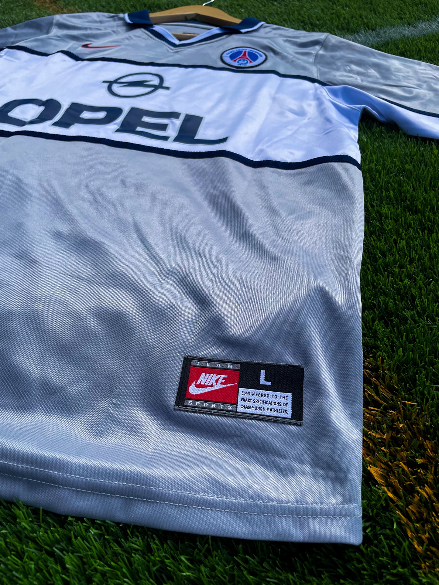 Close-up of vintage PSG crest and Opel sponsor

