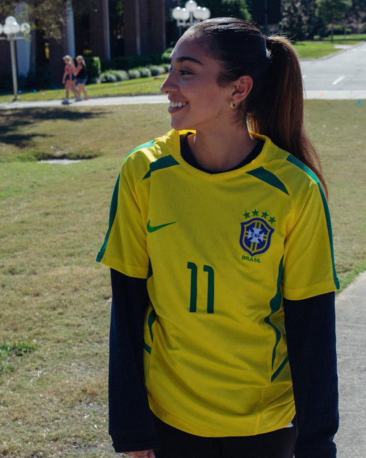 Model wearing the Brazil 2002 Ronaldo & Ronaldinho jerseys styled with sneakers
