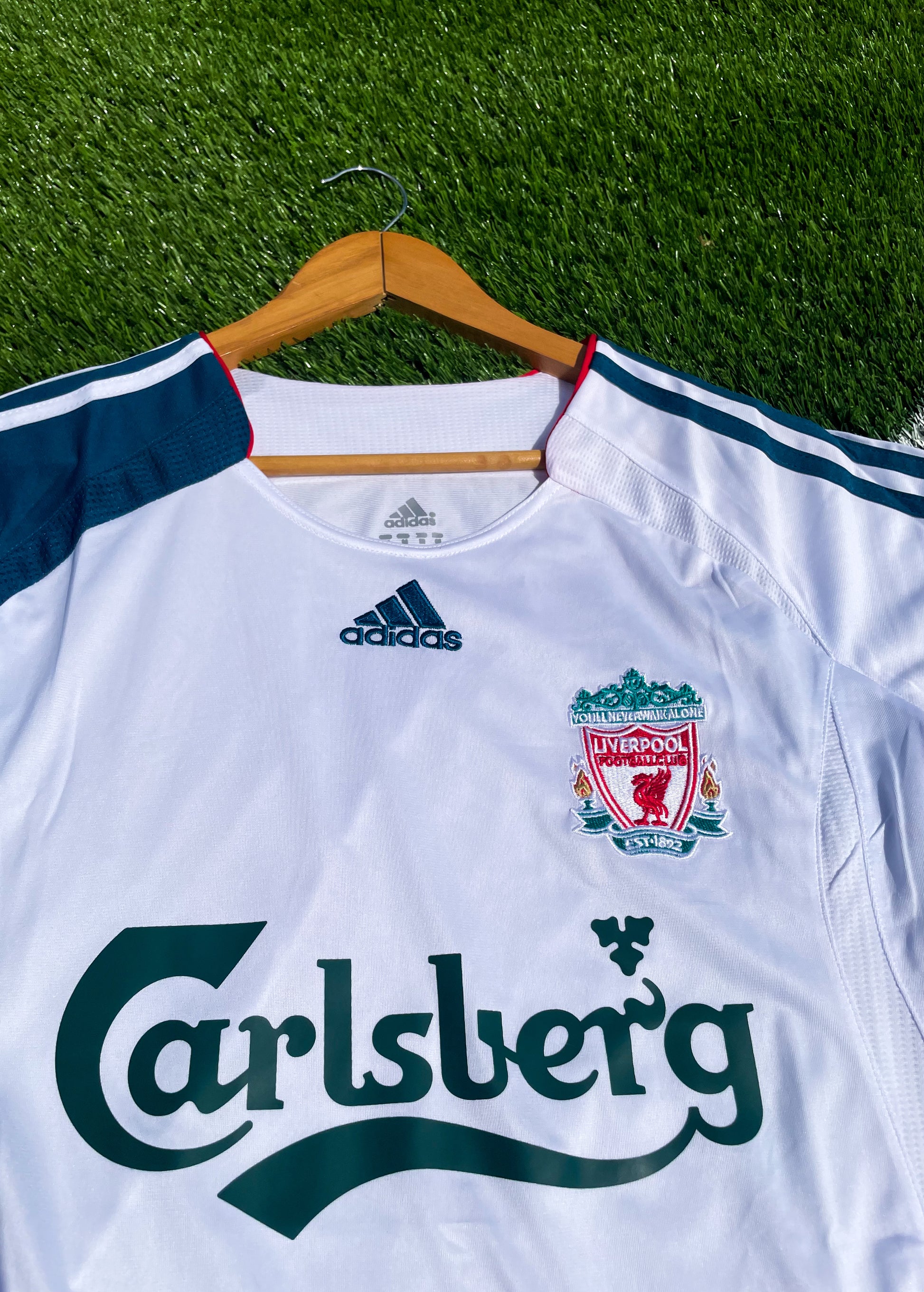 Close-up of club crest, sponsor, and Adidas detailing

