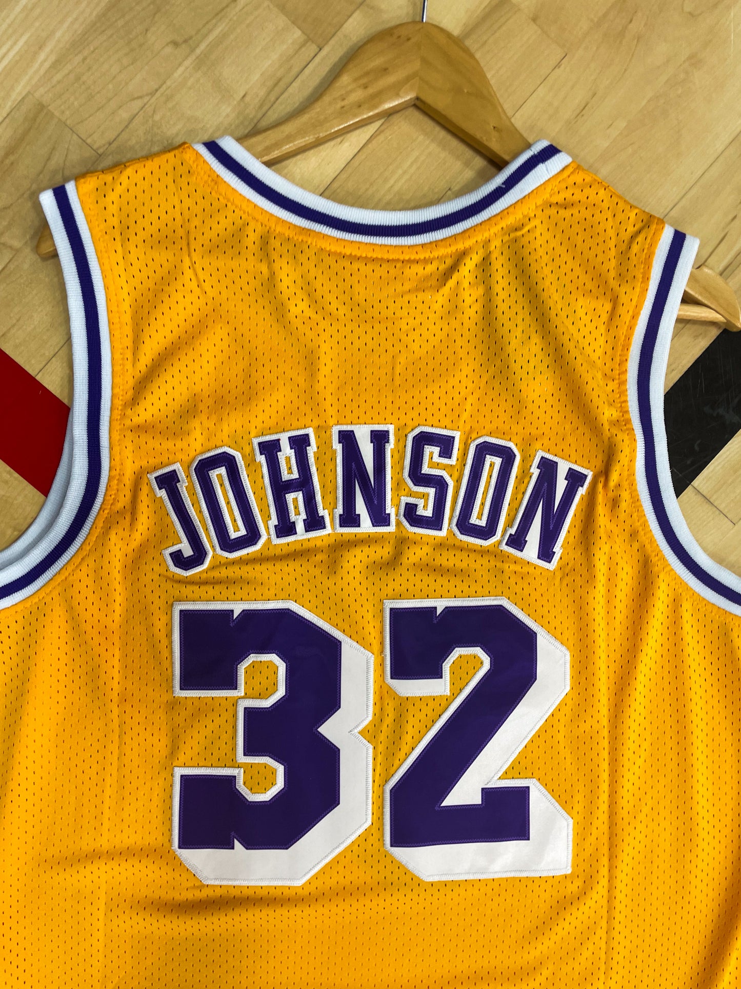 Close-up of Lakers logo and mesh fabric details with gold trim

