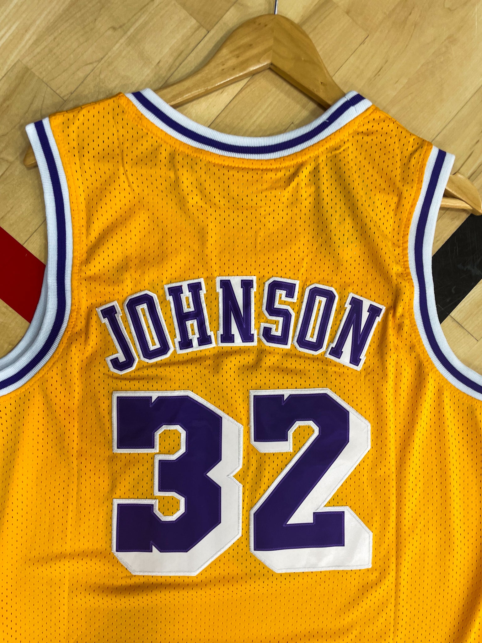 Close-up of Lakers logo and mesh fabric details with gold trim

