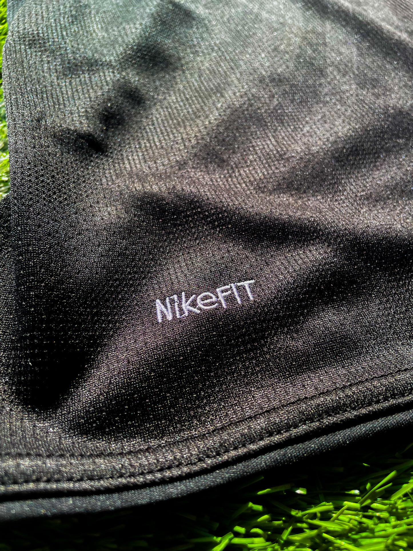 Close-up of gold Nike logo and club crest

