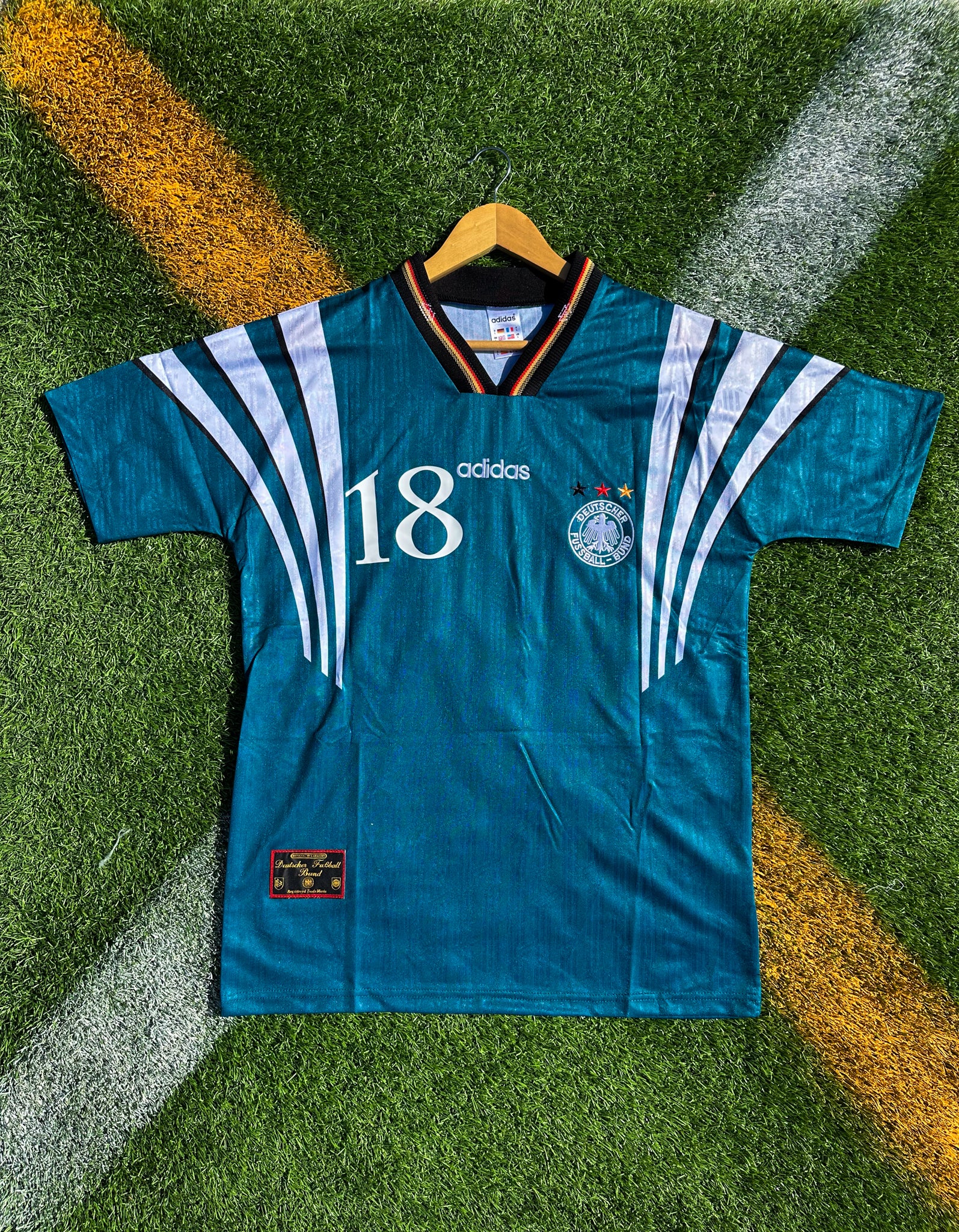 Front view of Germany 1996 away jersey in green with diamond pattern


