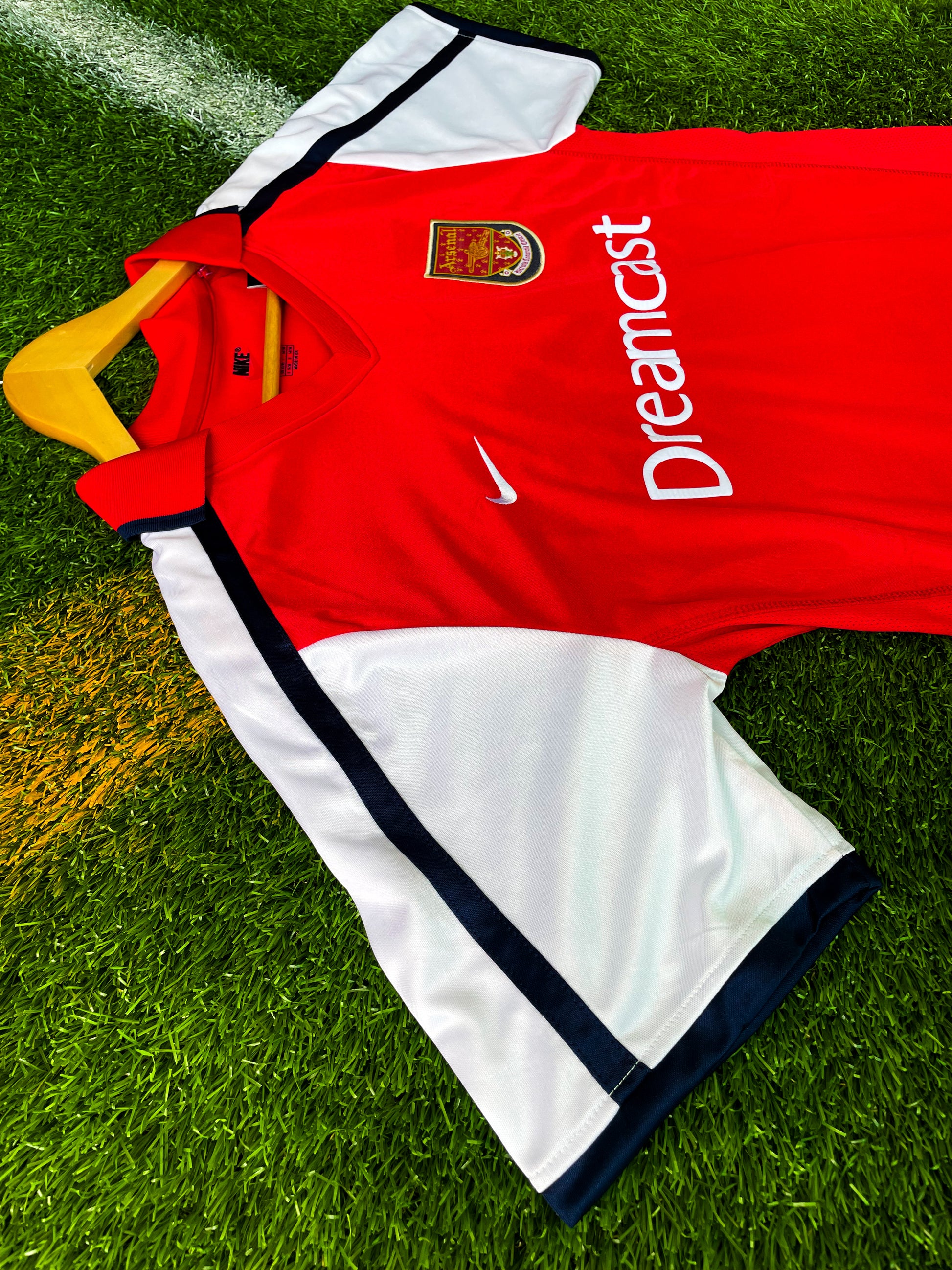Close-up of Dreamcast sponsor and Nike swoosh on vintage Arsenal shirt


