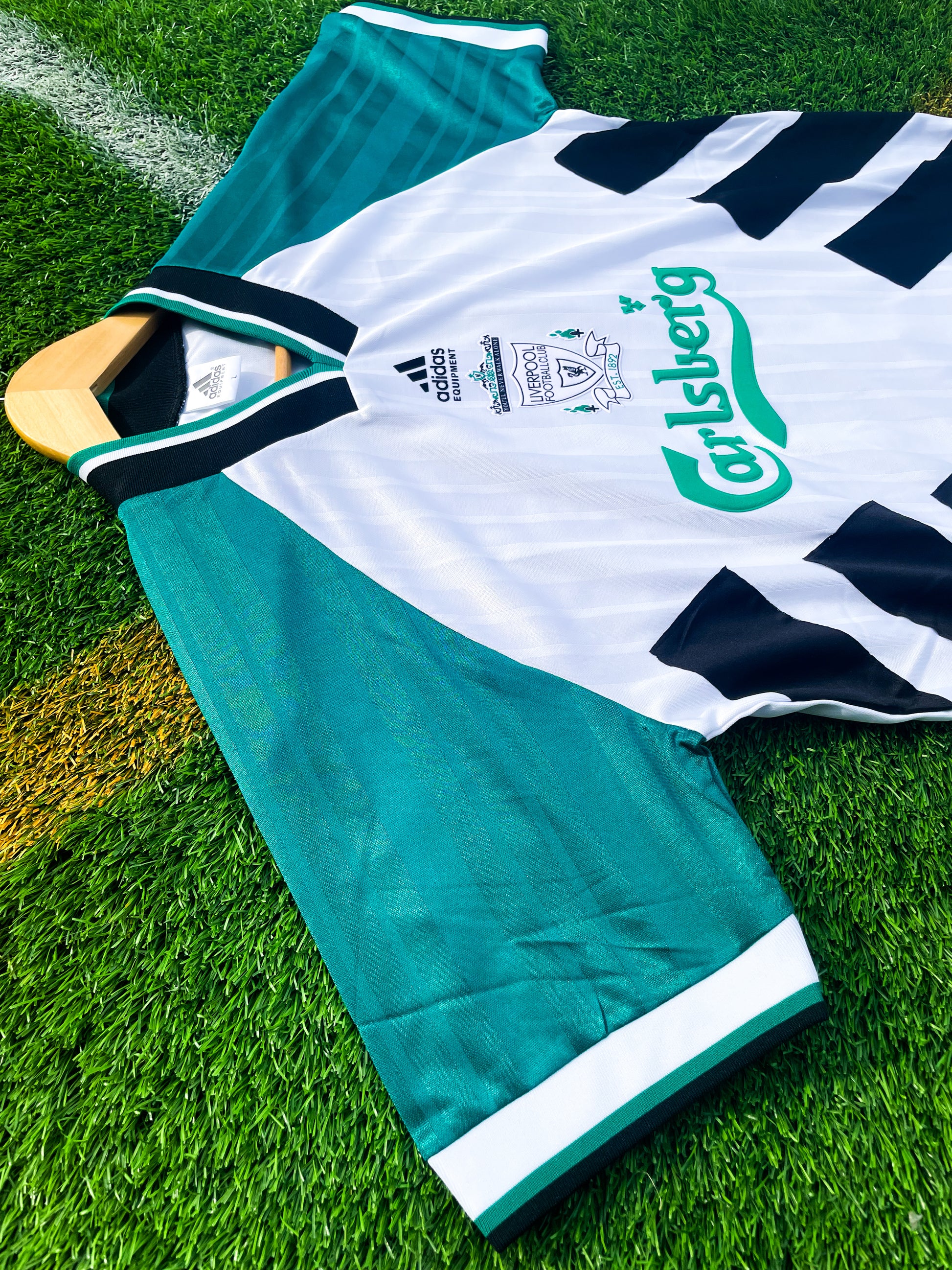 Side angle showing black stripes on sleeves and vintage fit

