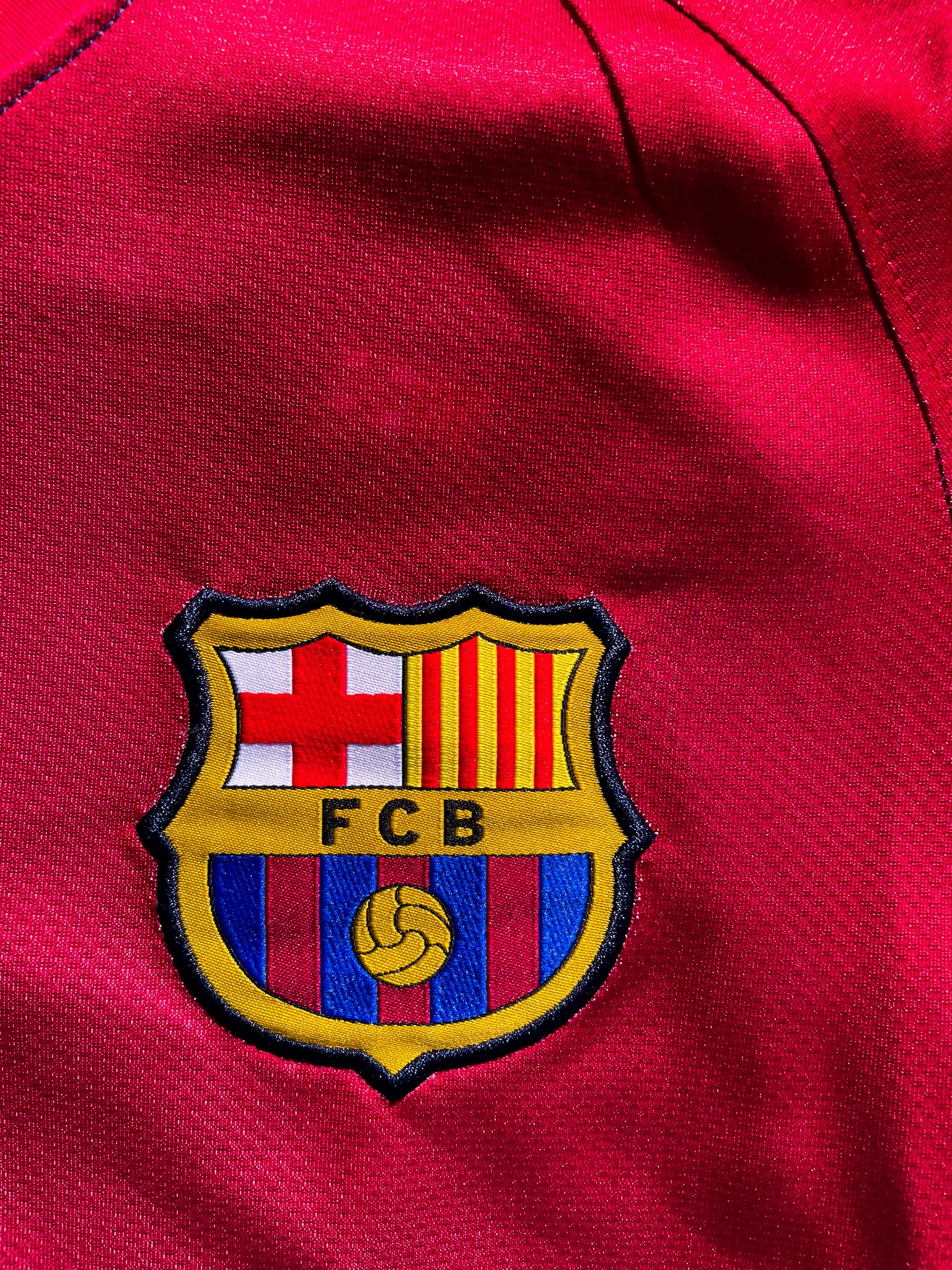 Close-up of Nike logo and club crest on the split-color design

