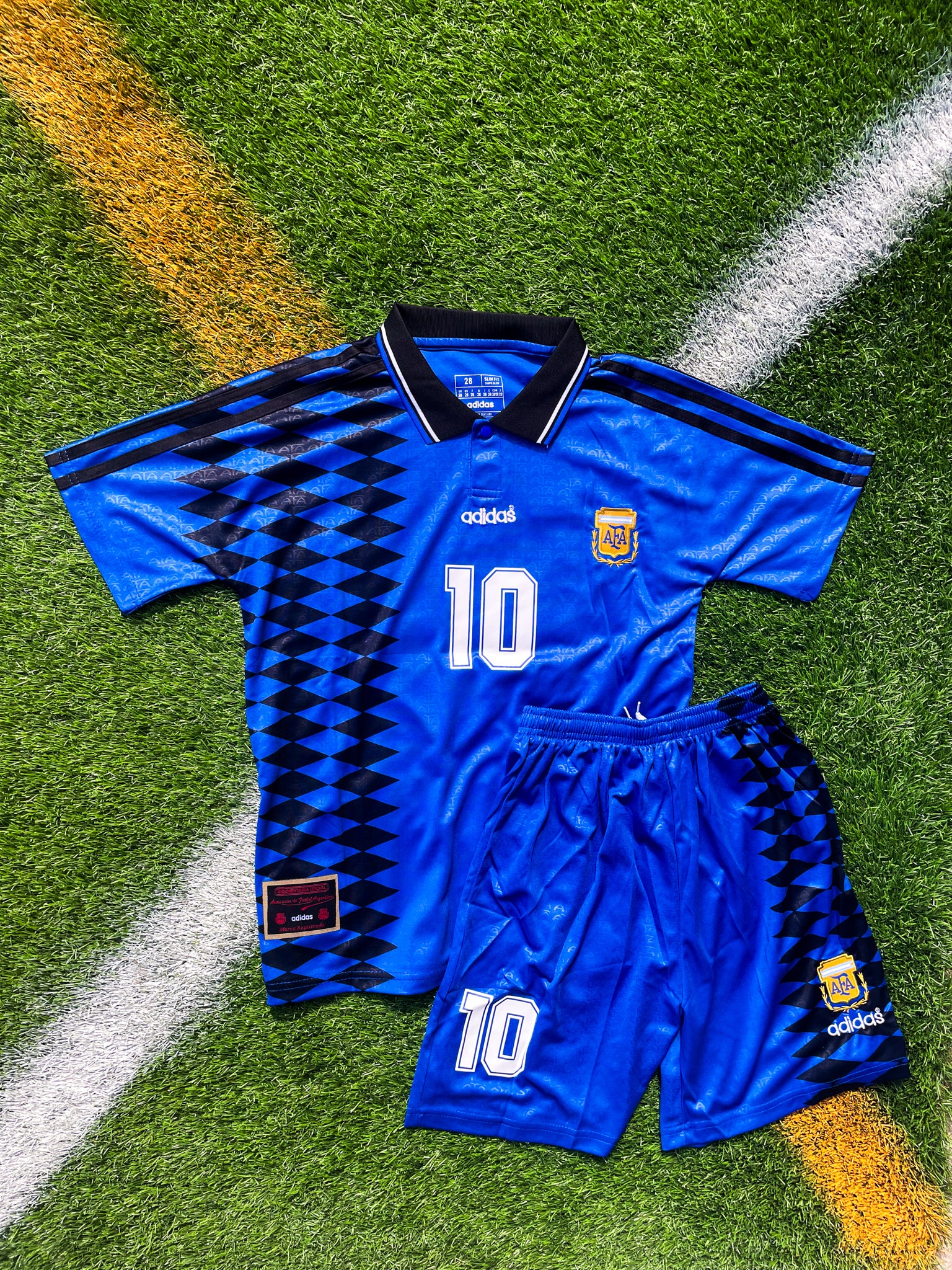Front view of the Argentina 1994 Away Kids Jersey with bold blue geometric design and AFA crest.