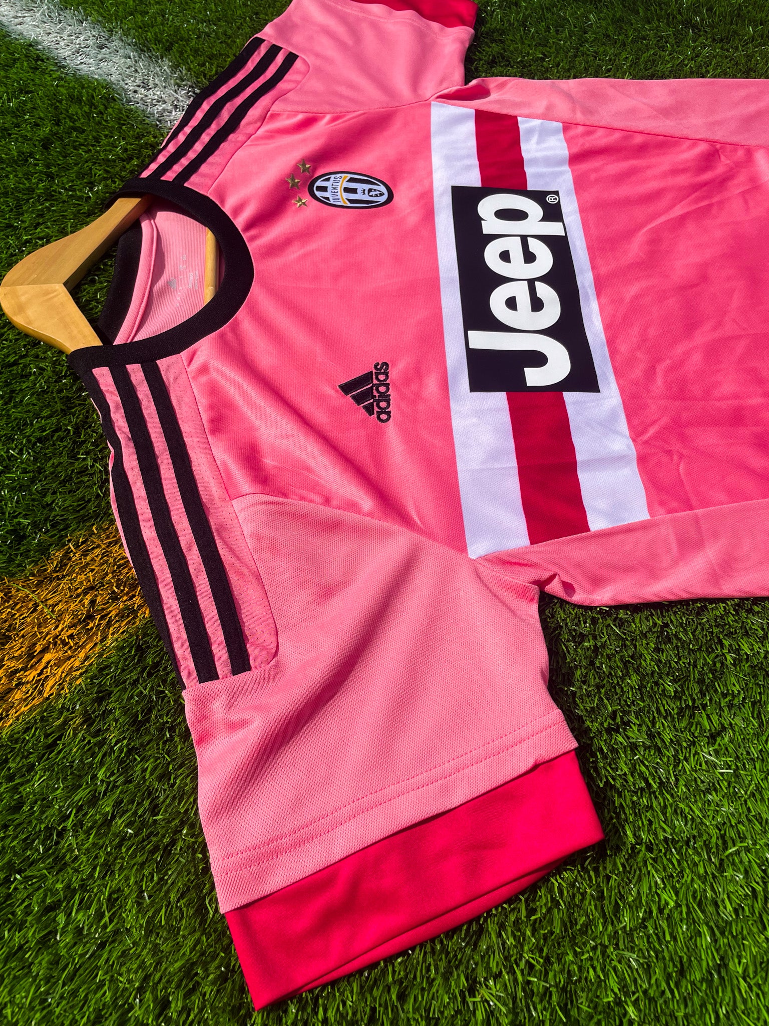 Close-up of Juventus crest, Adidas logo, and black trim

