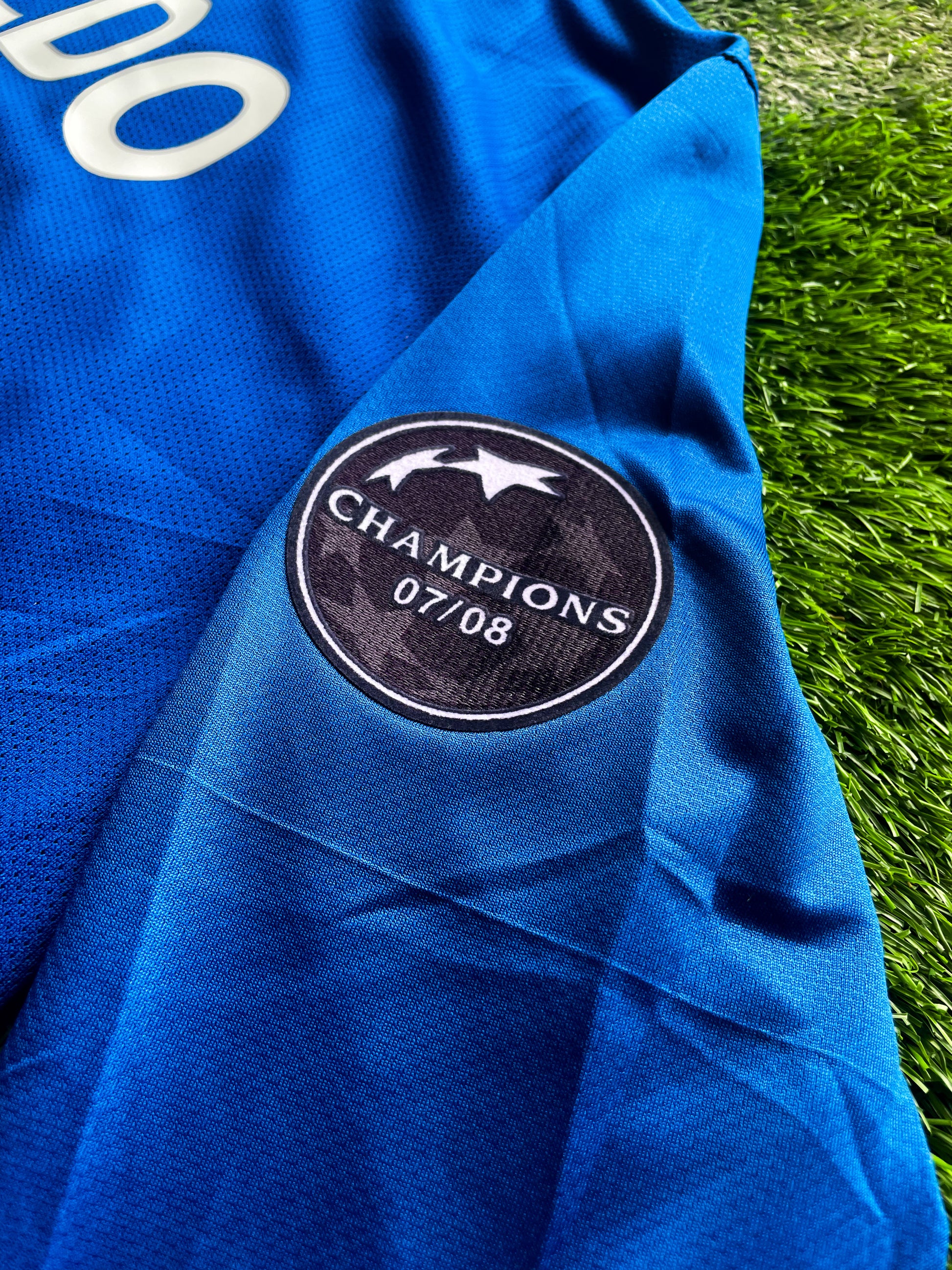 Close-up of Nike logo and Manchester United crest

