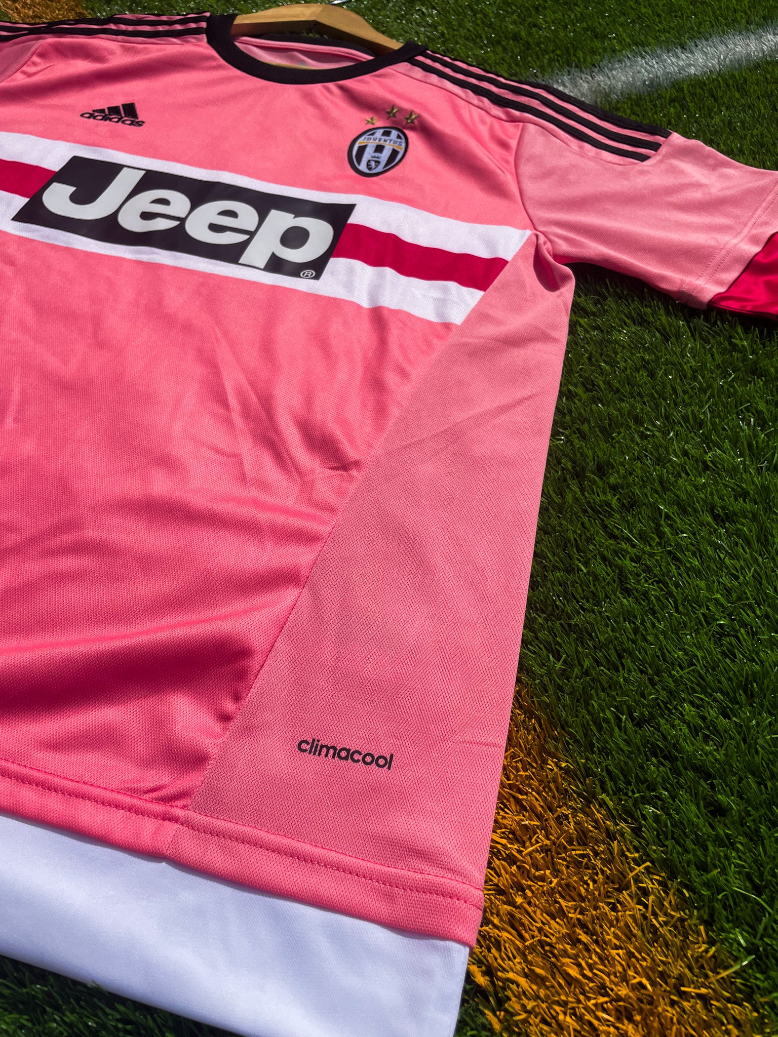 Close-up of Juventus crest, Adidas logo, and black trim

