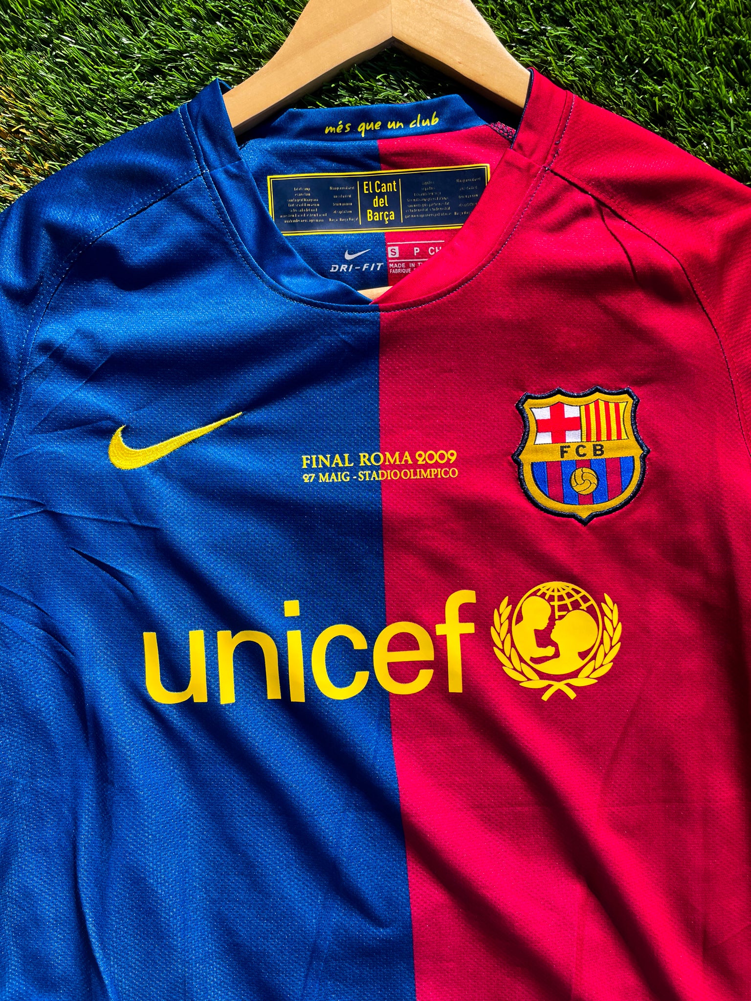 Close-up of Nike logo and club crest on the split-color design

