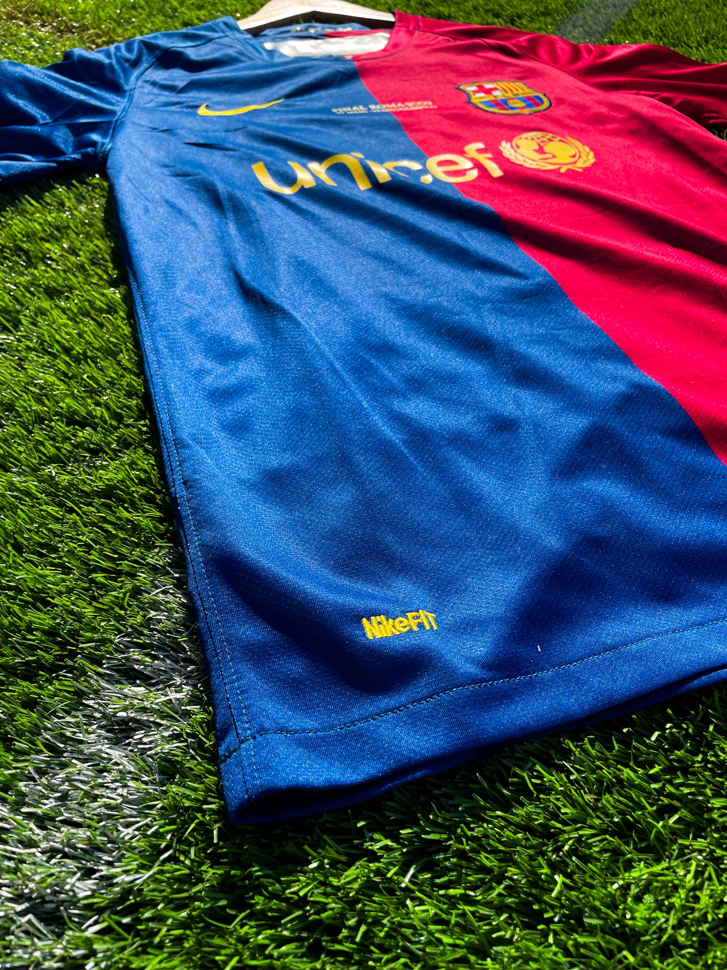 Close-up of Nike logo and club crest on the split-color design

