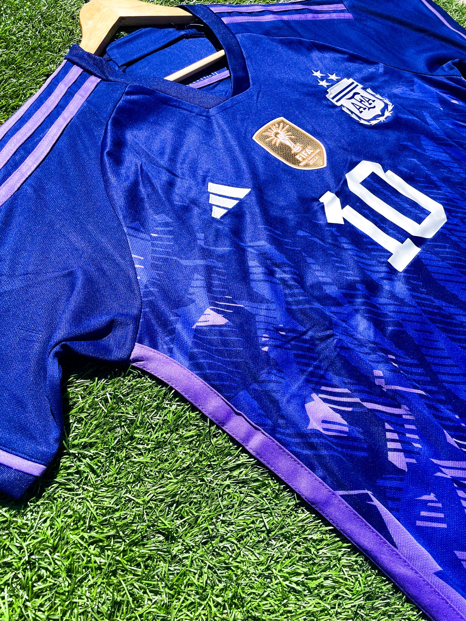 Close-up of FIFA World Champions badge on Messi Argentina 2023 Away Kit.