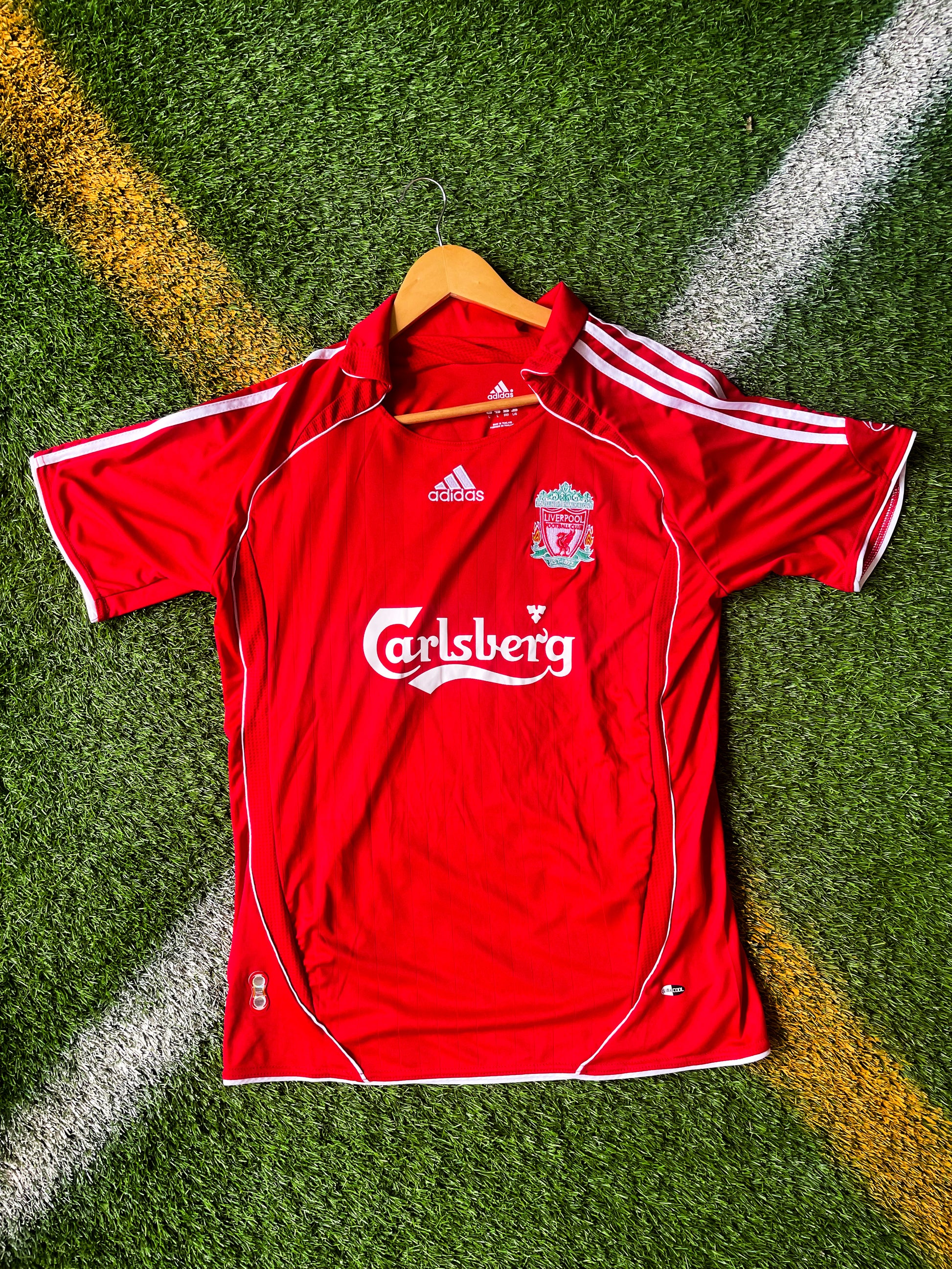 Front view of Liverpool 2006 Home Jersey in red with Adidas and sponsor logos

