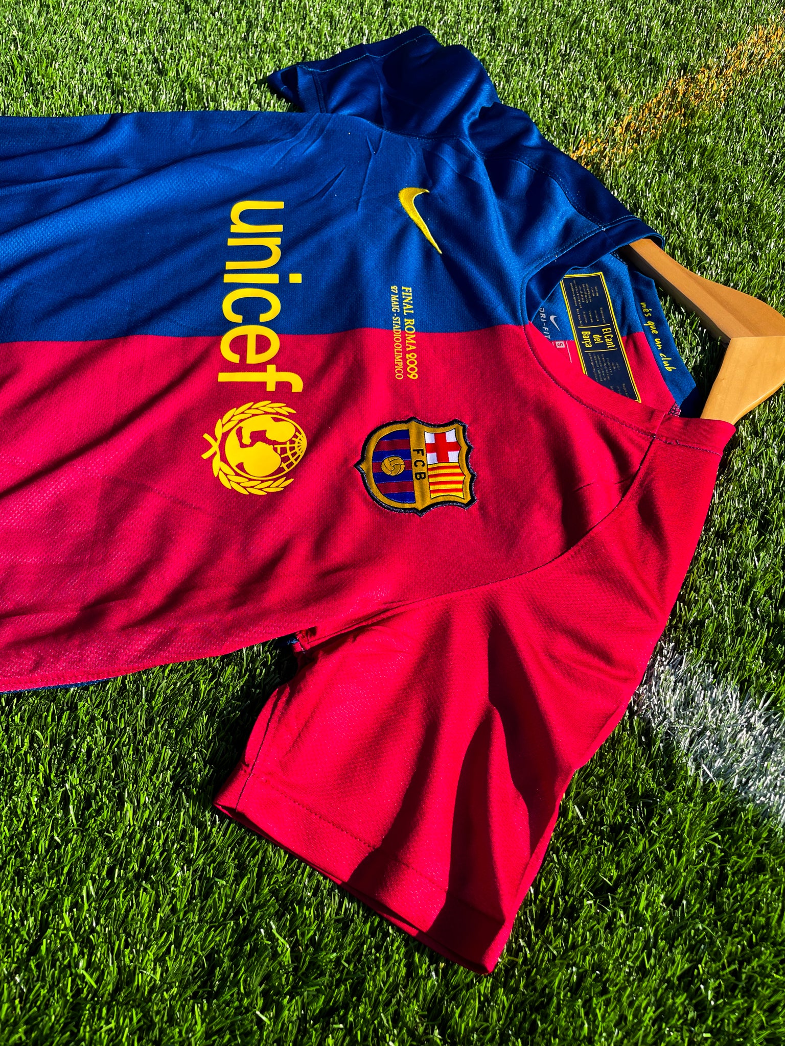Close-up of Nike logo and club crest on the split-color design

