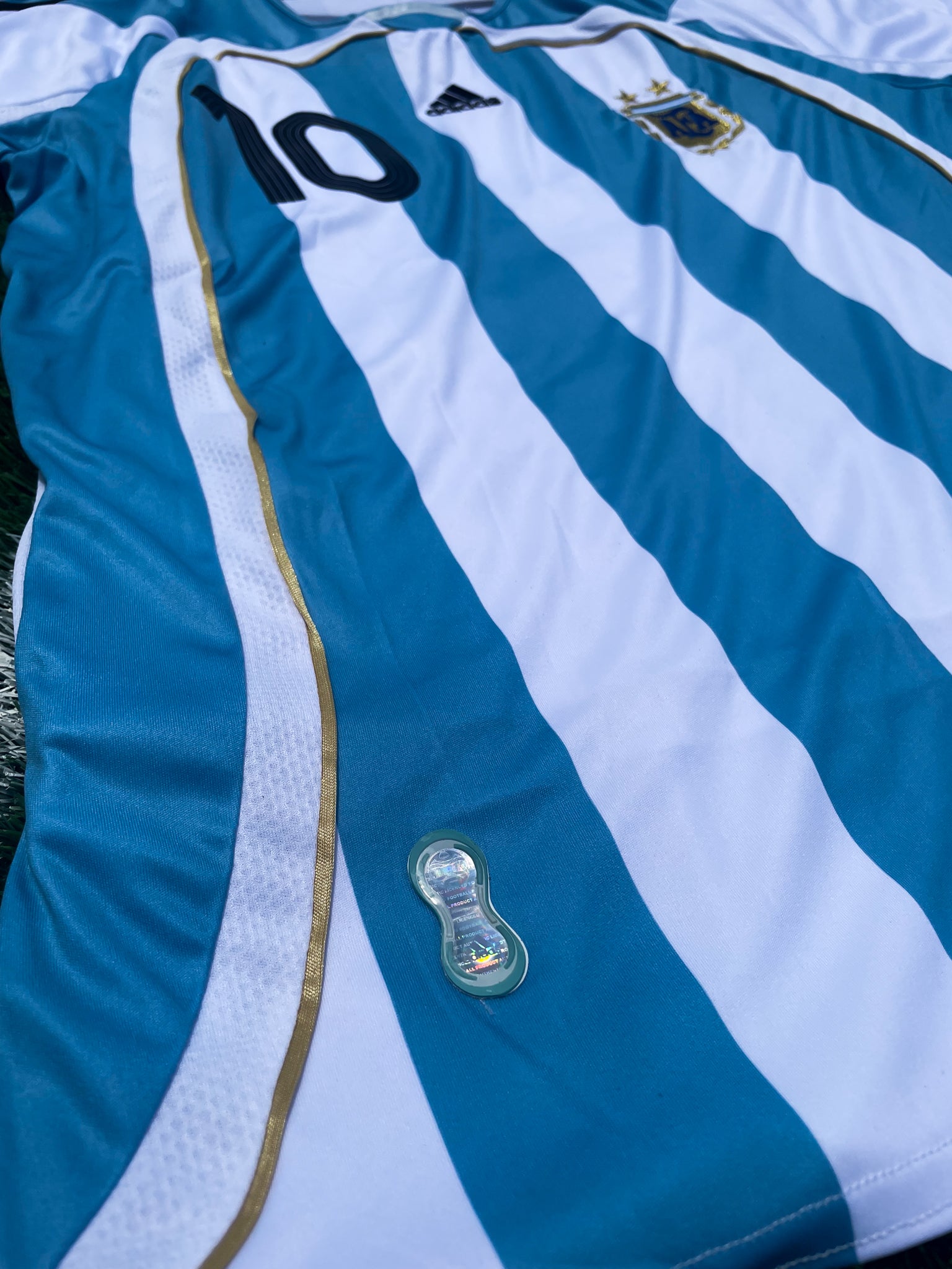 Detail shot of the jersey's fabric texture and gold accents.