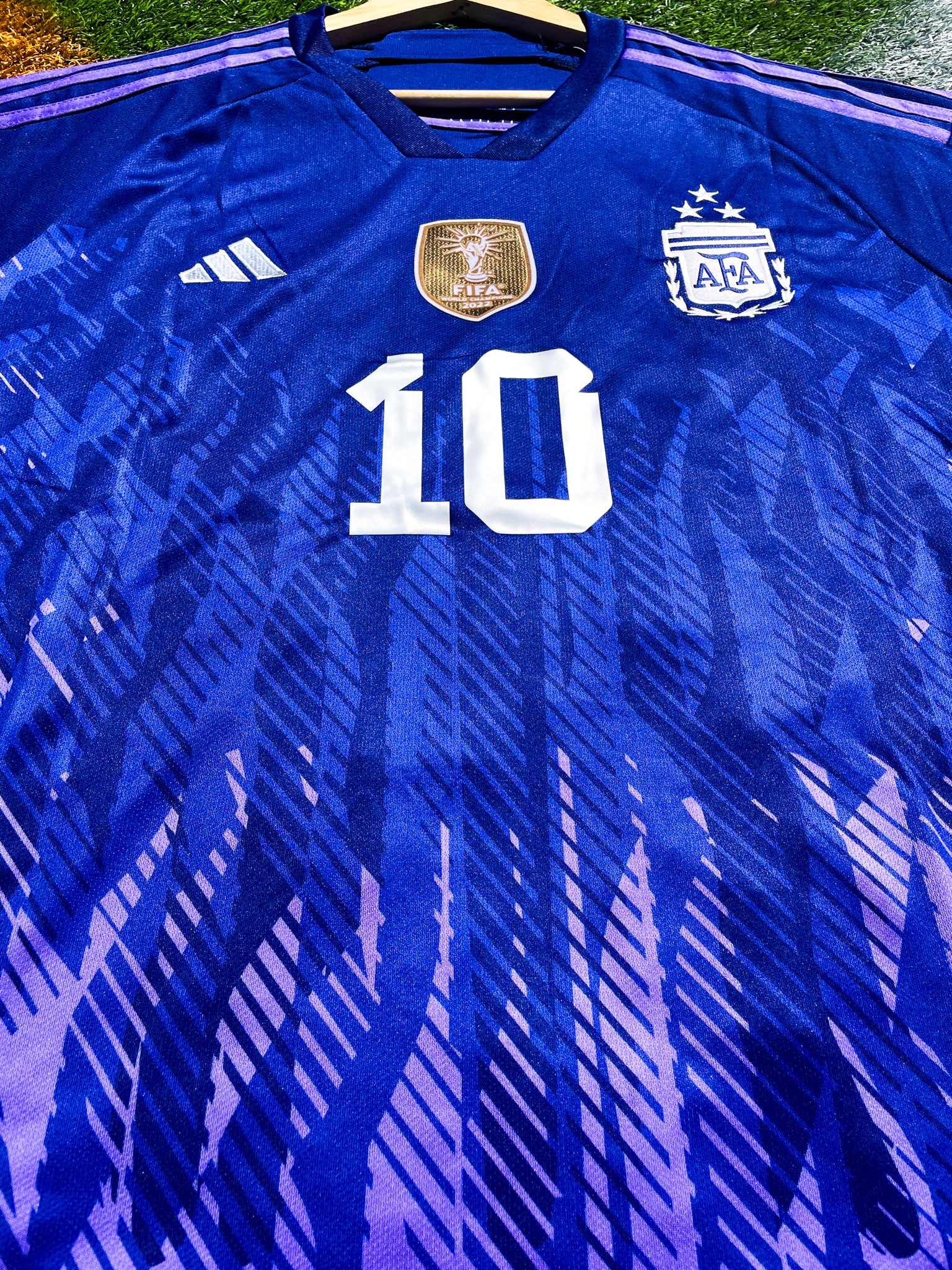 Close-up of FIFA World Champions badge on Messi Argentina 2023 Away Kit.