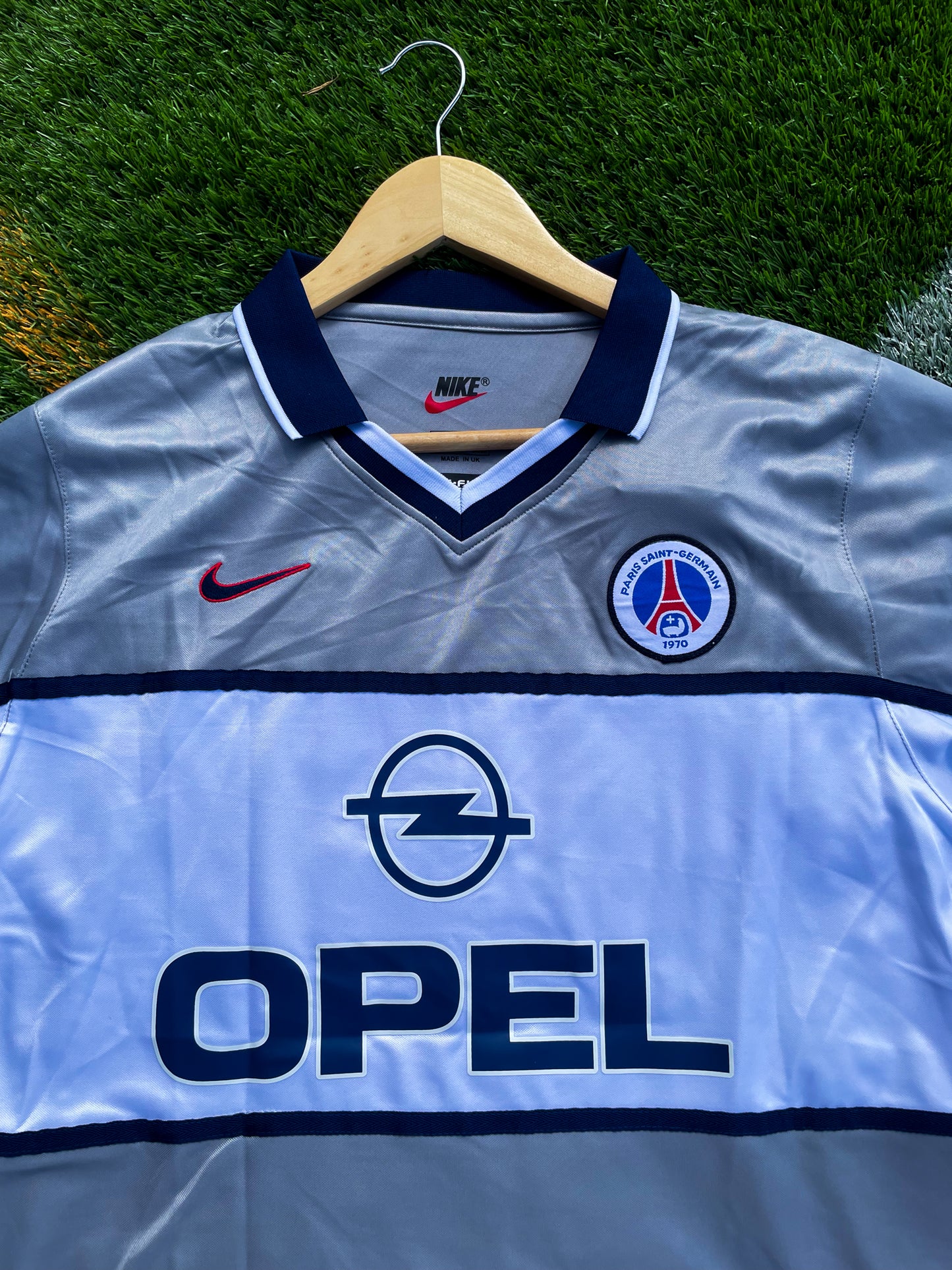 Close-up of vintage PSG crest and Opel sponsor

