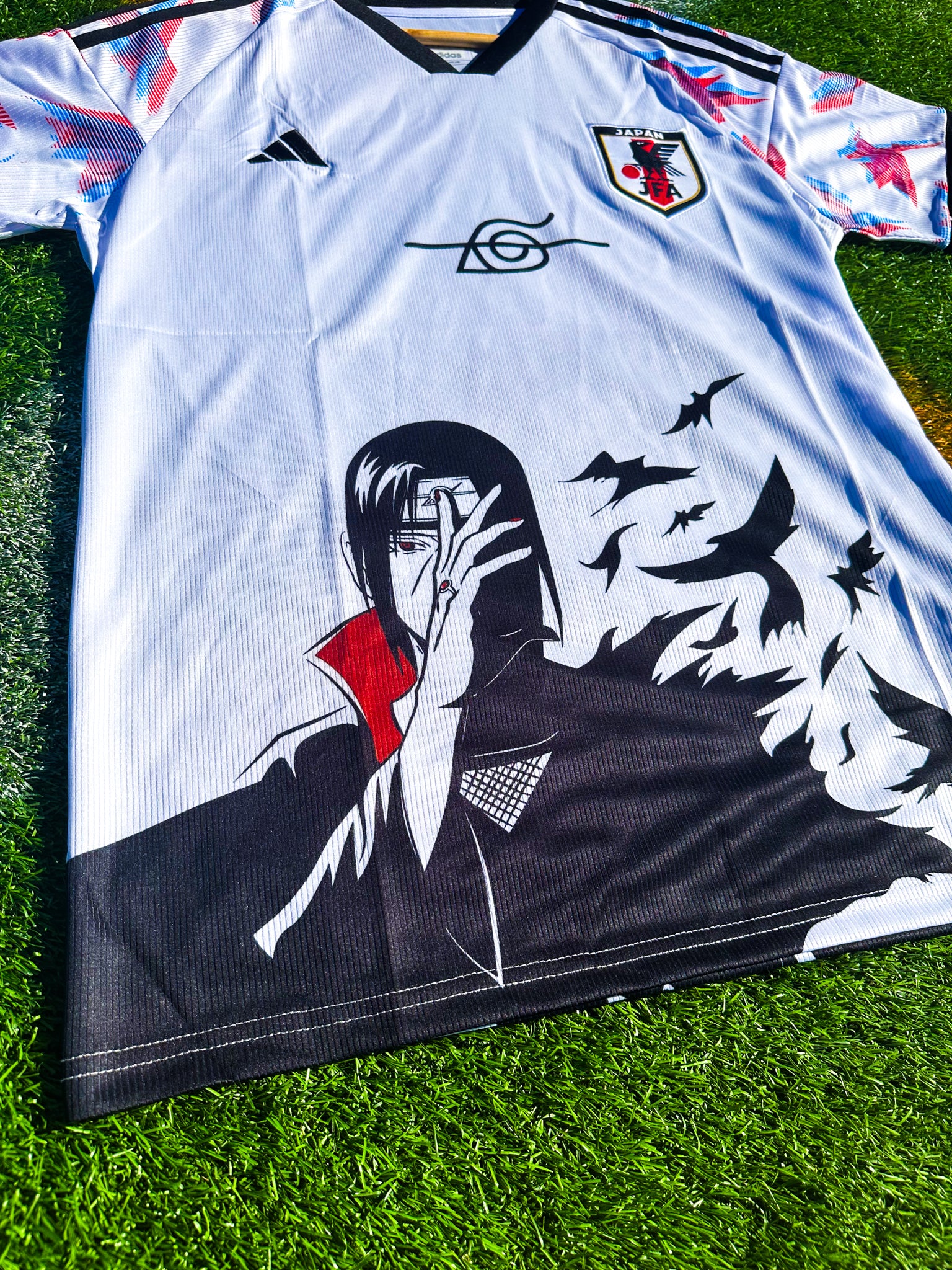 Close-up of Naruto graphic and JFA crest

