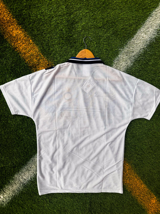 Back view showing full white layout and classic fit

