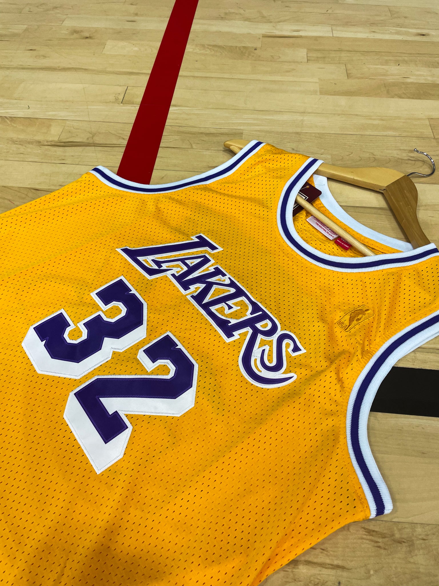 Close-up of Lakers logo and mesh fabric details with gold trim


