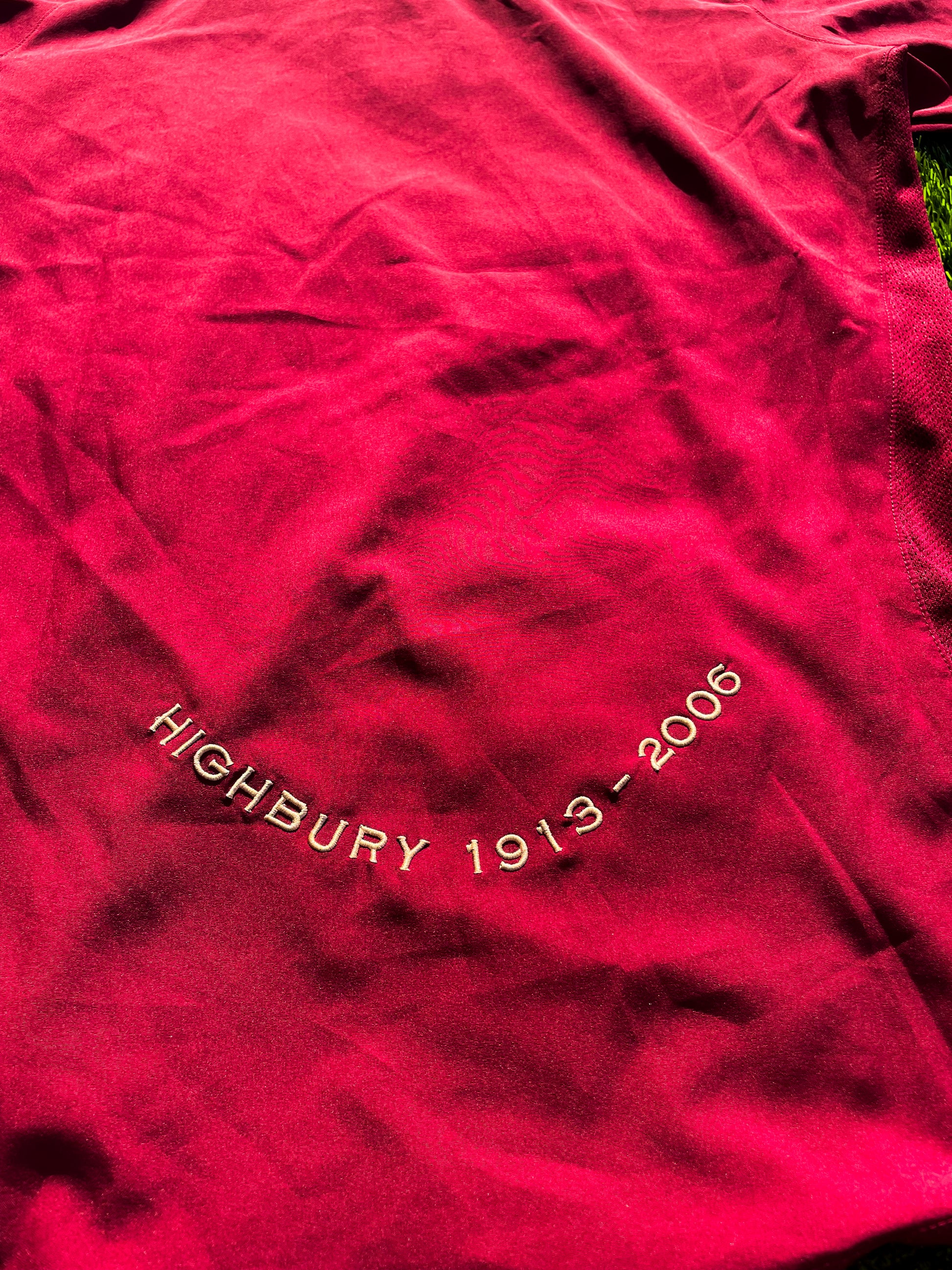 Detail of collar and sleeve with burgundy accents

