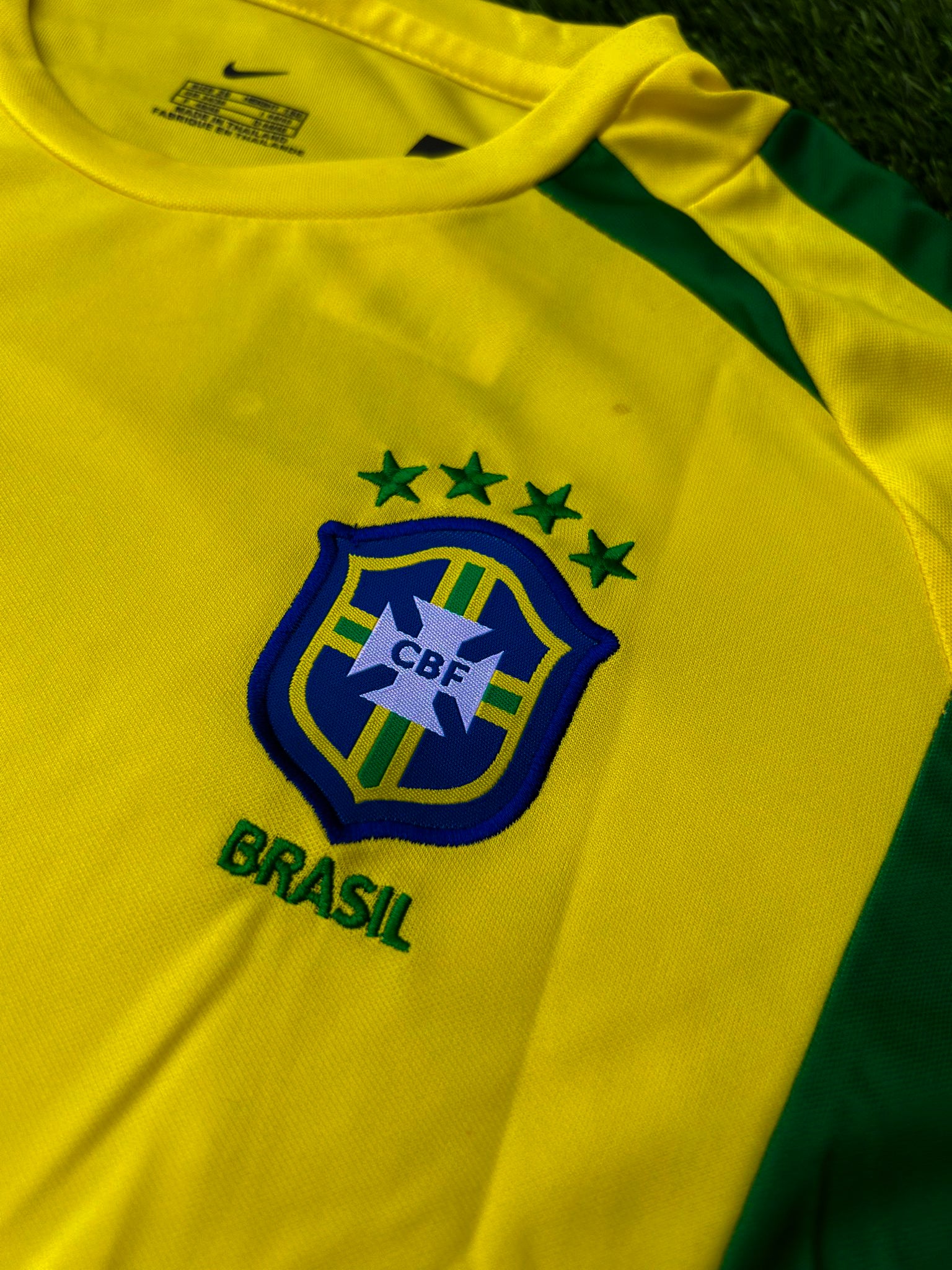 Close-up of embroidered crest and green sleeve trim
