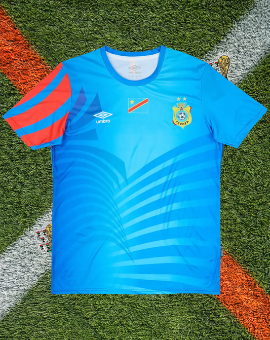 DR Congo 2023/2024  Home - Umbro Sky Blue Graphic Pattern Asymmetric Red Sleeve Crew-Neck