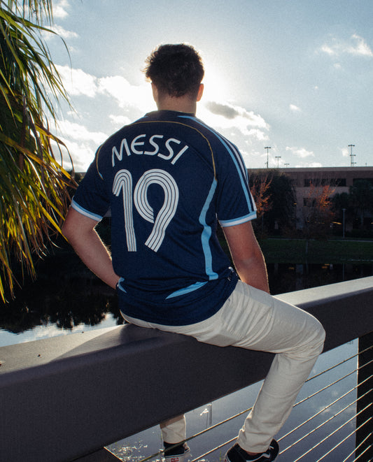 Model wearing the Argentina 2006 Away Messi #19 Jersey, styled with complementary accessories.