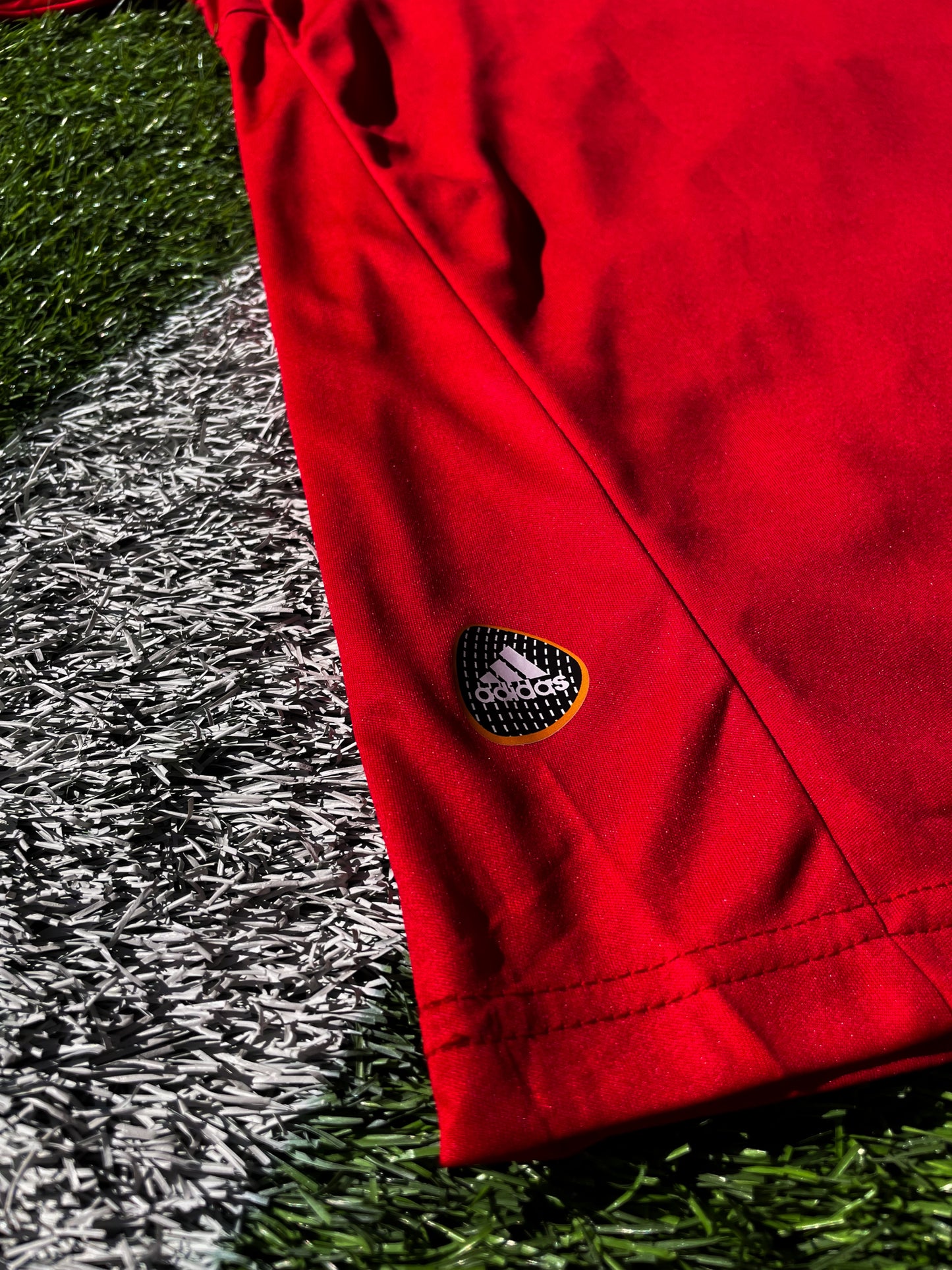 Close-up of the RFEF crest and Adidas shoulder logo


