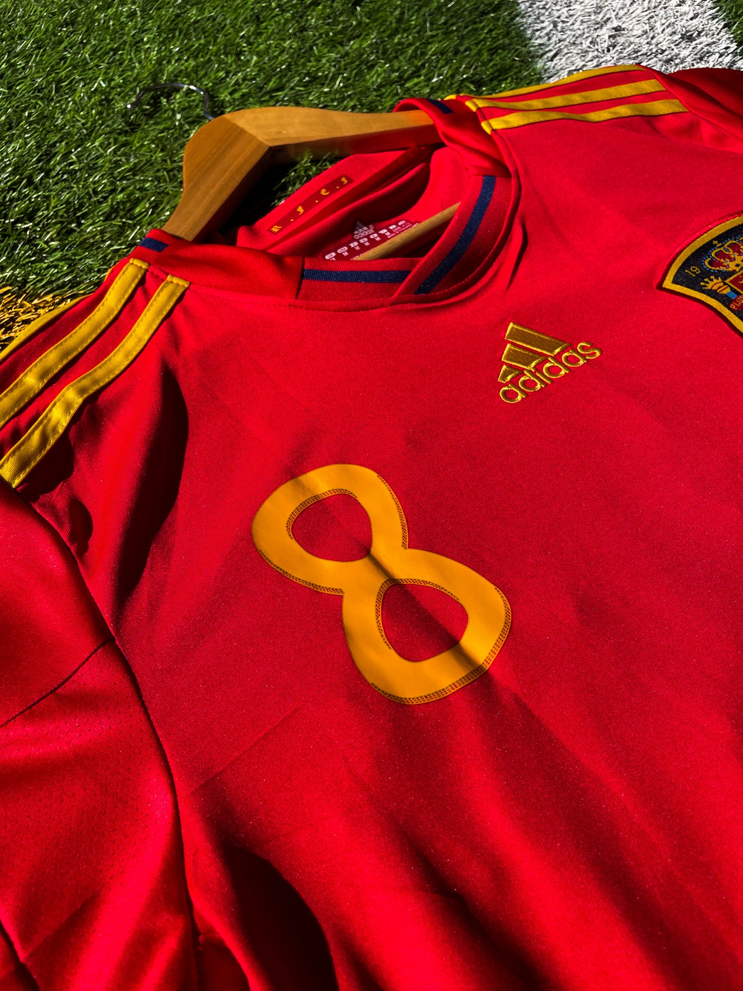 Close-up of the RFEF crest and Adidas shoulder logo

