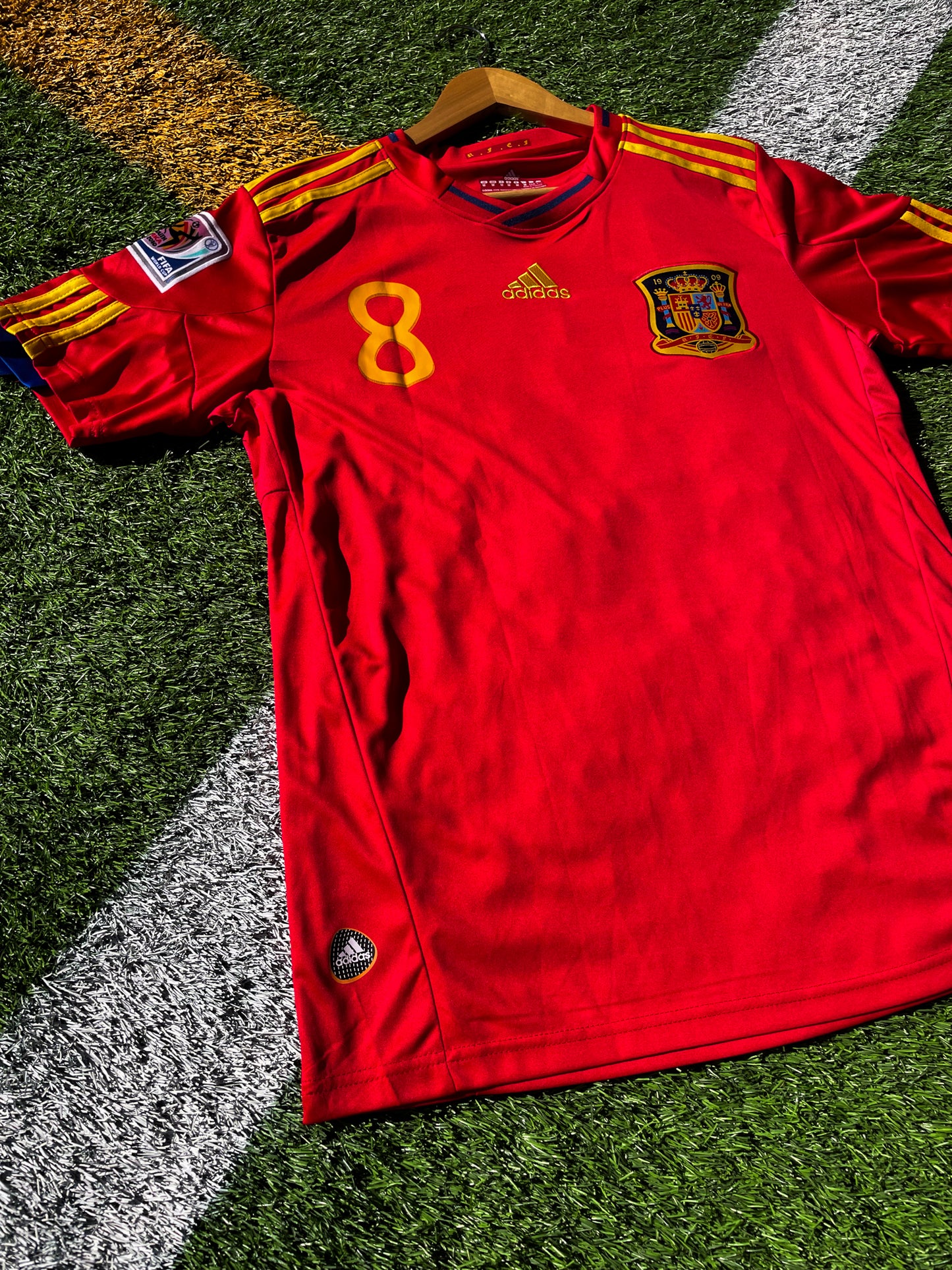 Close-up of the RFEF crest and Adidas shoulder logo


