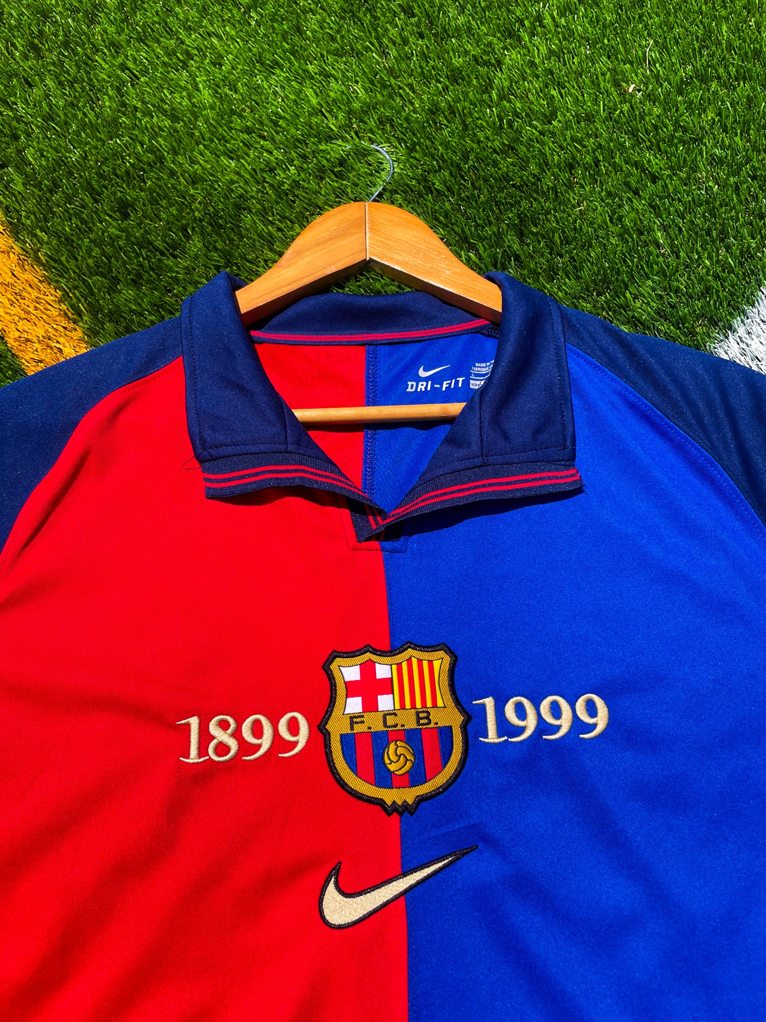 Close-up of 100 years anniversary badge and Nike swoosh


