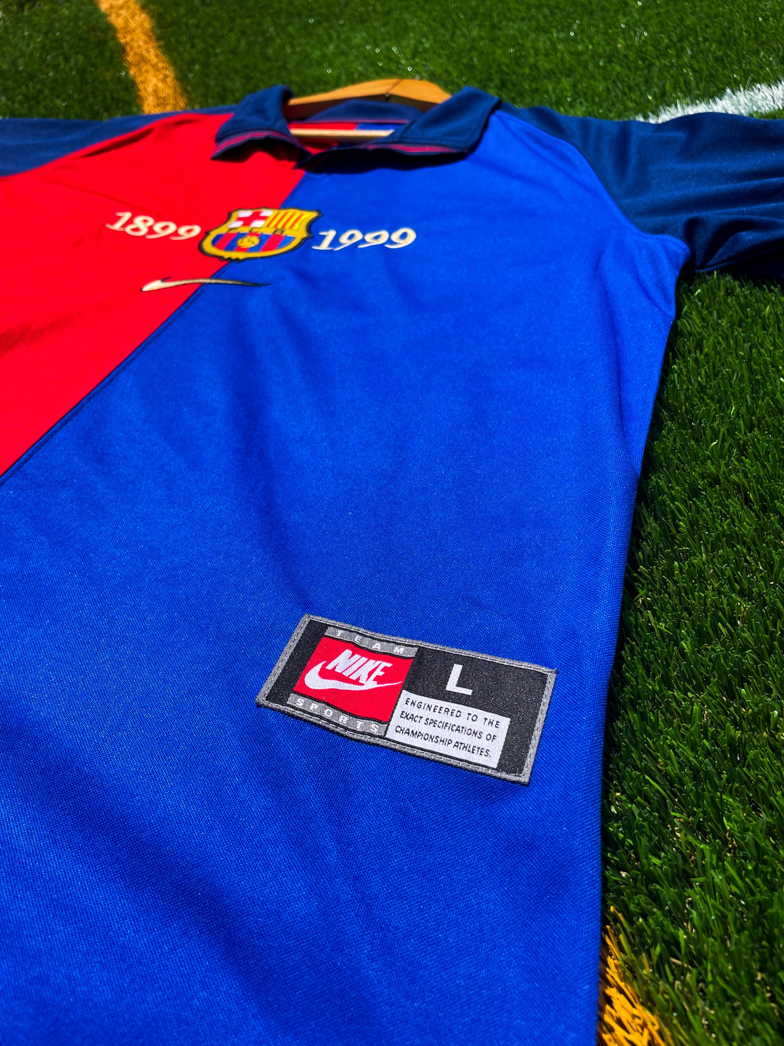 Close-up of 100 years anniversary badge and Nike swoosh

