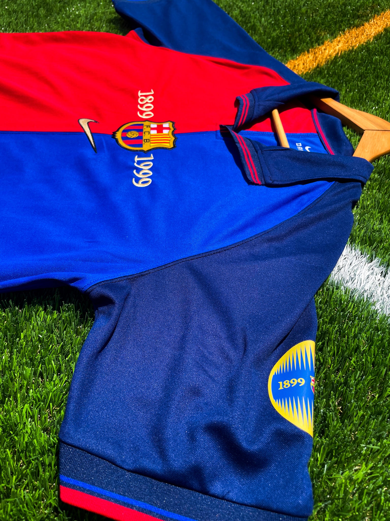 Close-up of 100 years anniversary badge and Nike swoosh

