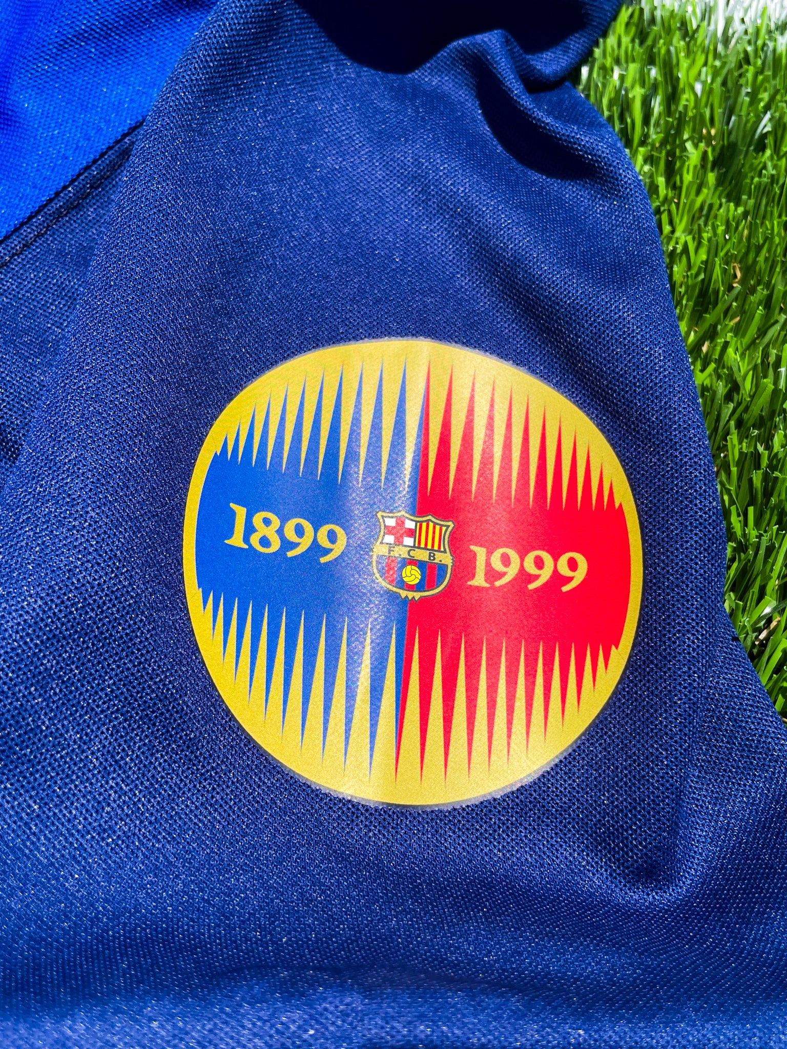 Close-up of 100 years anniversary badge and Nike swoosh

