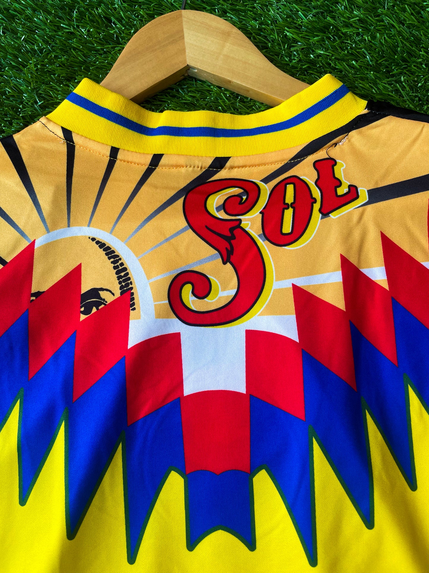 Close-up of sponsor logo and blue accents on jersey

